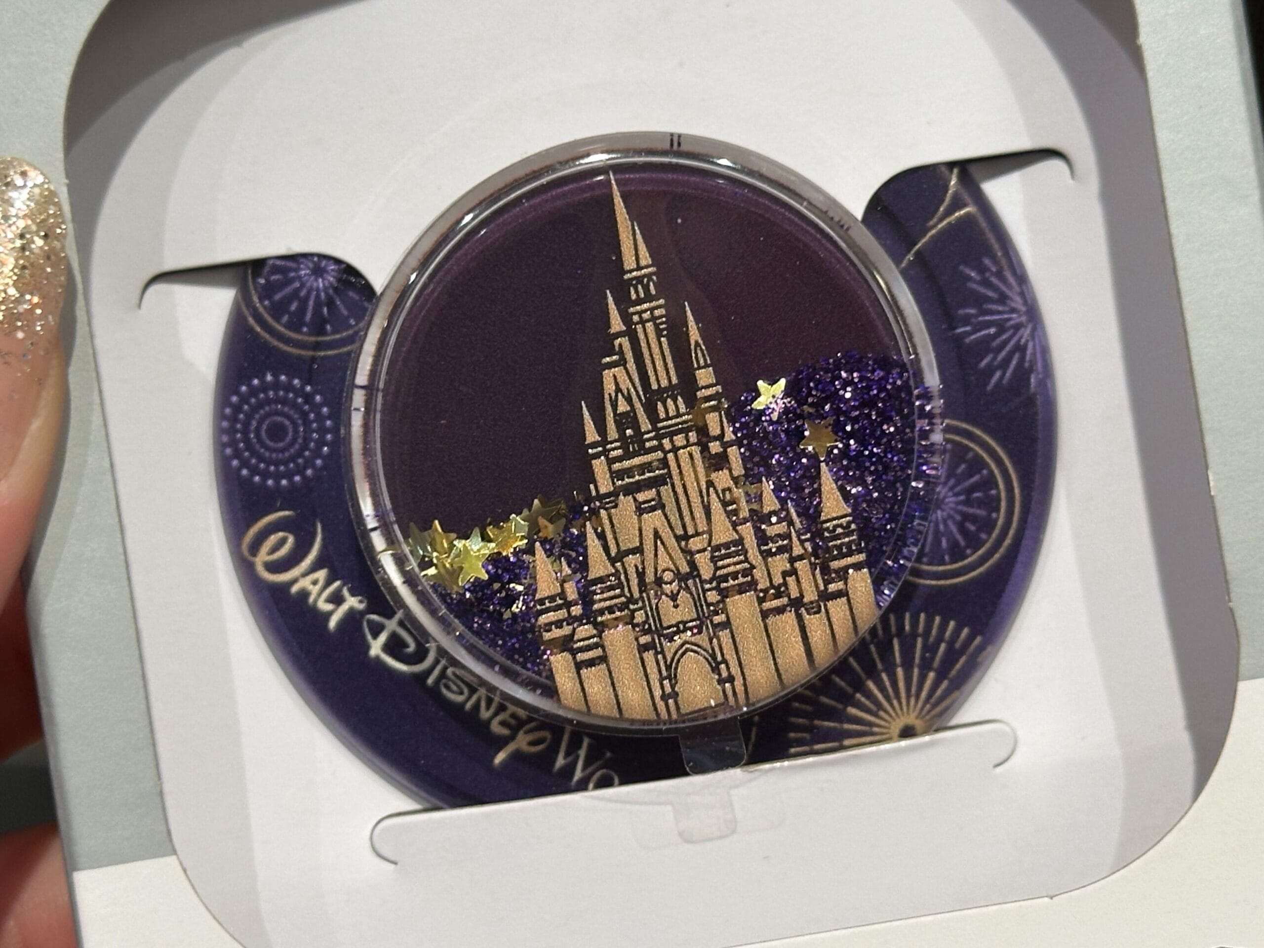 A round Walt Disney World keepsake features a gold castle, purple glitter, and fireworks—perfect with your Purple Disney World Spirit Jersey.