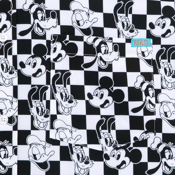 Checkered shirt with black and white cartoon character faces, featuring a small "RSVTS" label on the pocket.