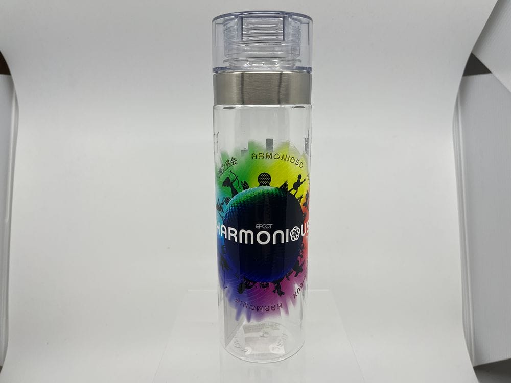 Clear water bottle with a silver lid, featuring a multicolored globe design and the word "Harmonious" on its body—a perfect find for your 2025 Spring Cleaning Auction.