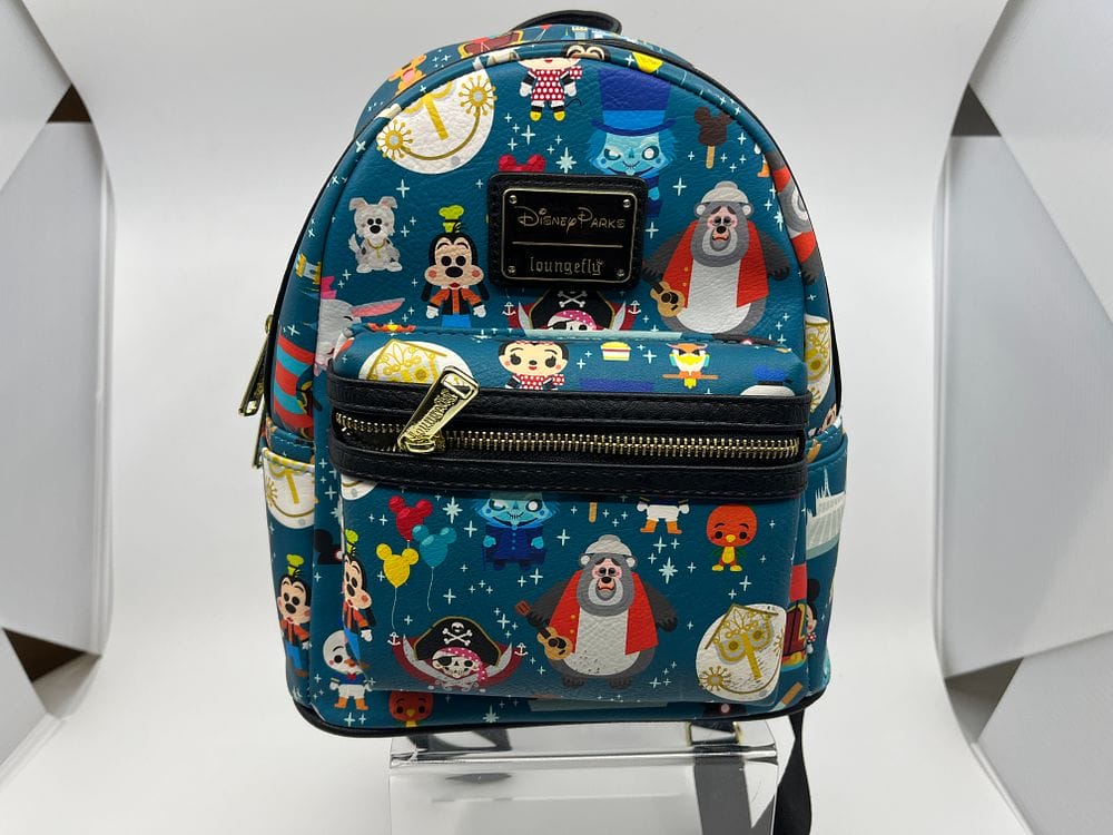 Blue Loungefly backpack with Disney Parks print, featuring vibrant cartoon characters and motifs, displayed on a clear stand. Part of the exclusive 2025 collection available at the Spring Cleaning Auction by WDWNT.