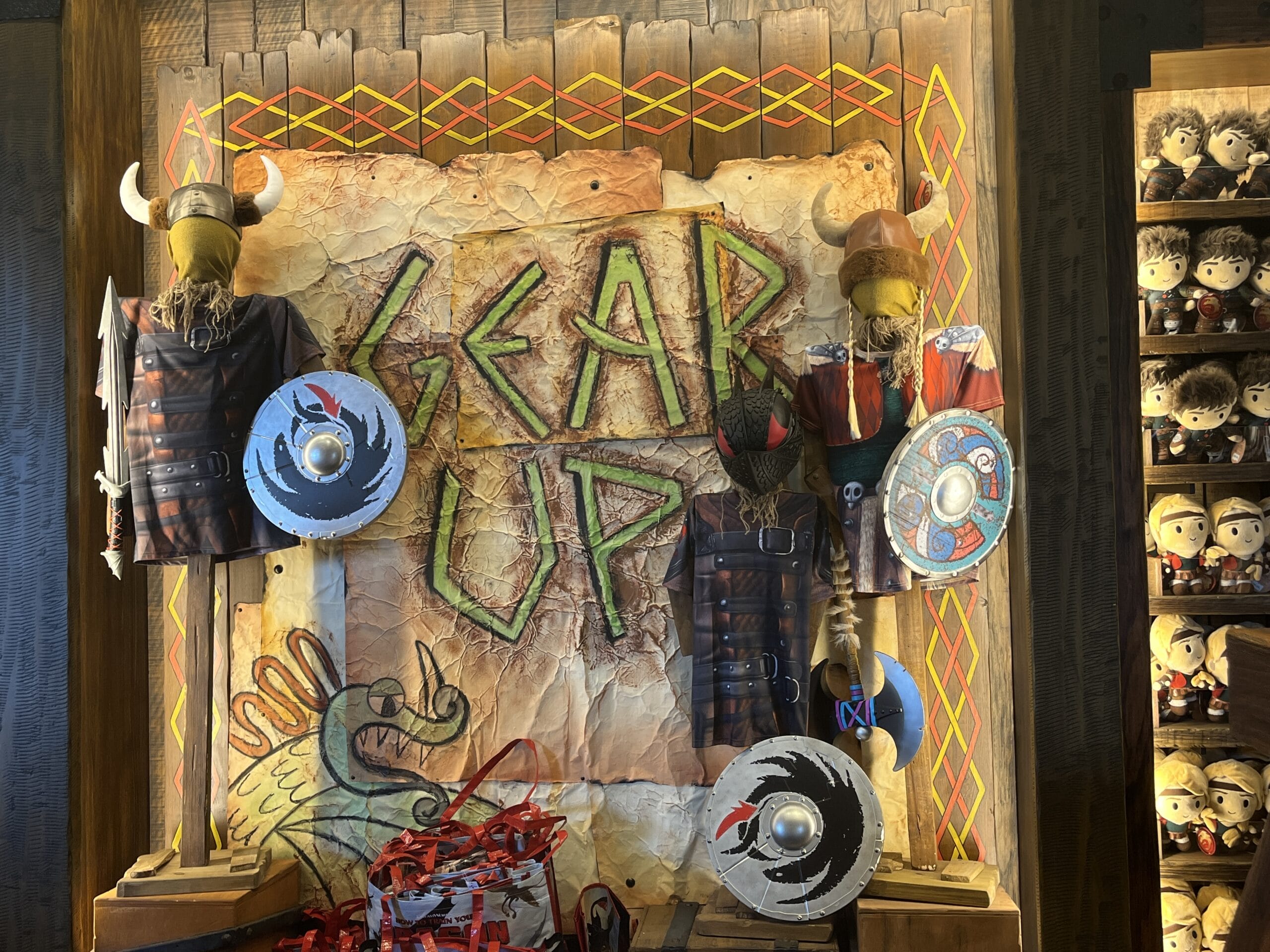 Viking Traders' costumes, shields, and axes with "Gear Up" sign and Viking décor.