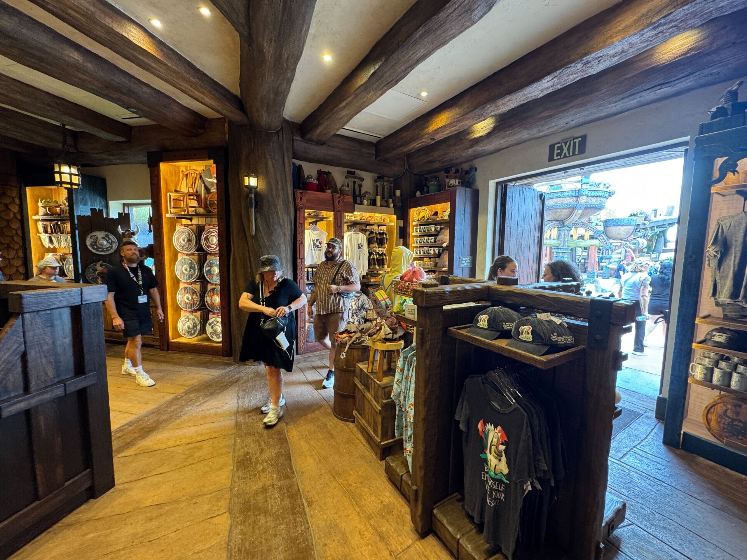 Viking Traders gift shop with rustic wooden beams, themed displays, and guests browsing near the entrance.