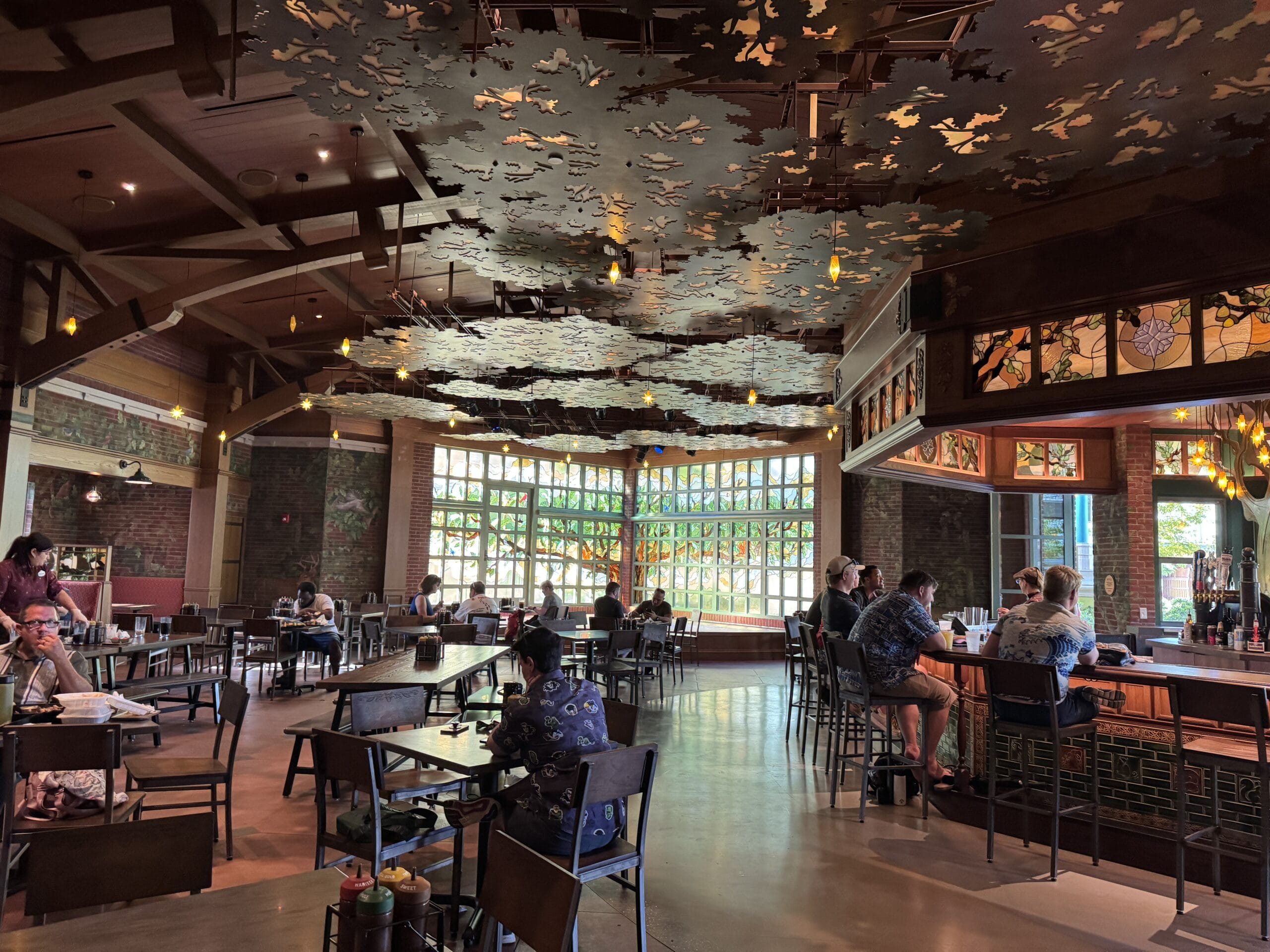 Spacious interior at The Oak & Star Tavern with wooden beams and decorative ceiling, much like the charm found in Epcot’s UK Pavilion.