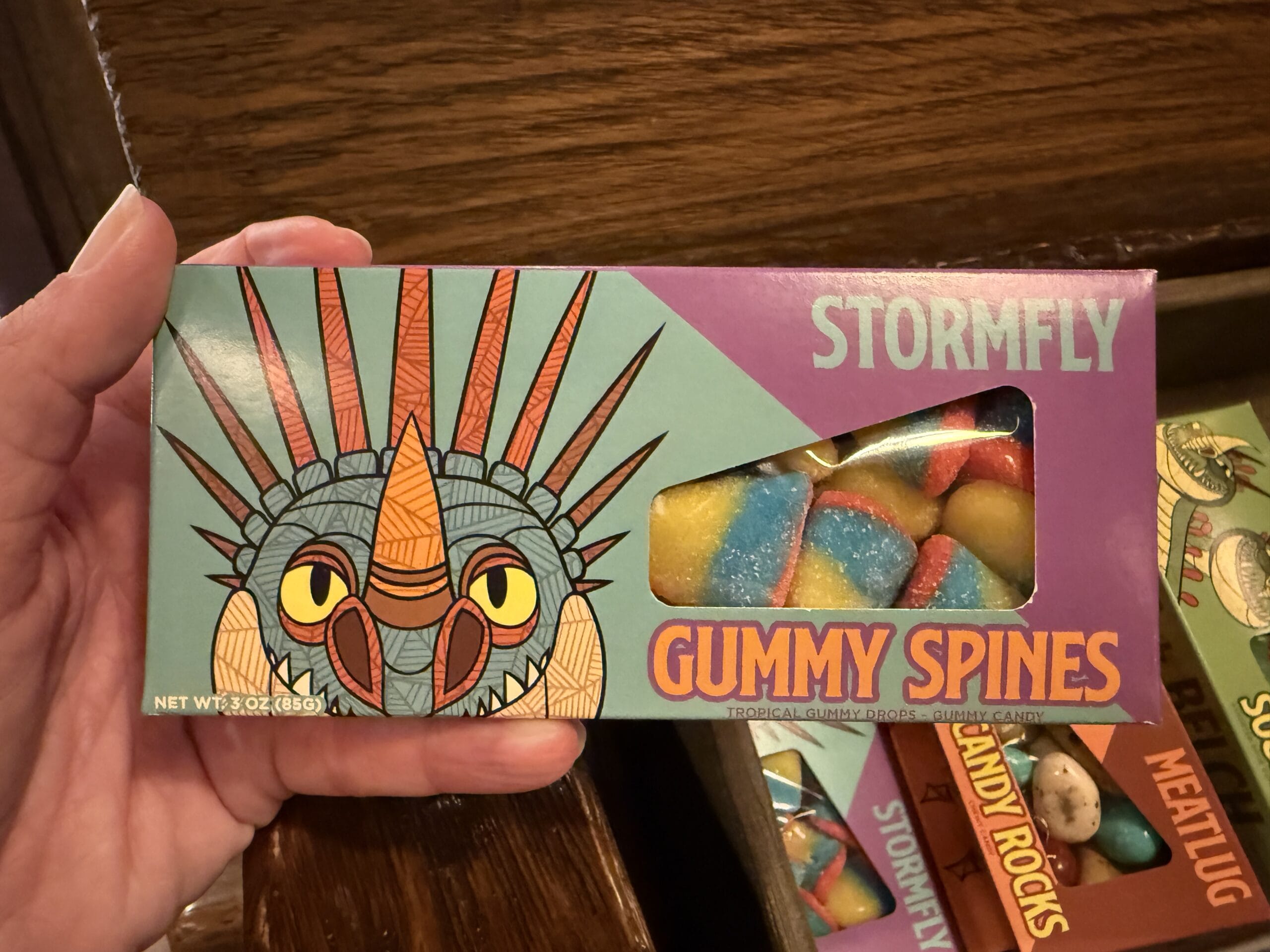 A hand holds a box of Stormfly Gummy Spines candy from Viking Traders, with colorful gummies visible through a window.