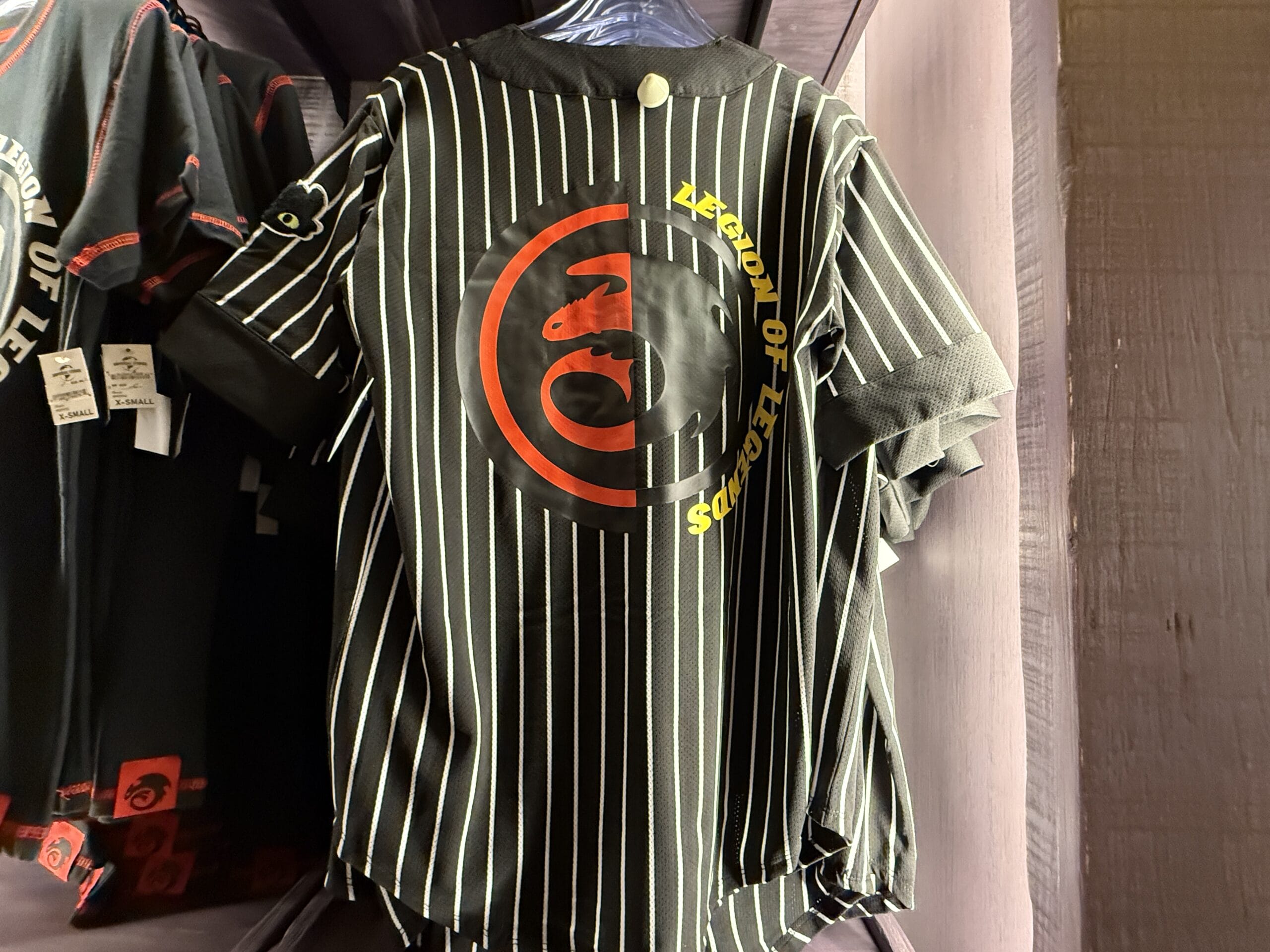 Black pinstripe shirt from Hiccup's Work Shop with a red dragon logo and yellow "Legend of LeGends" text on the back.
