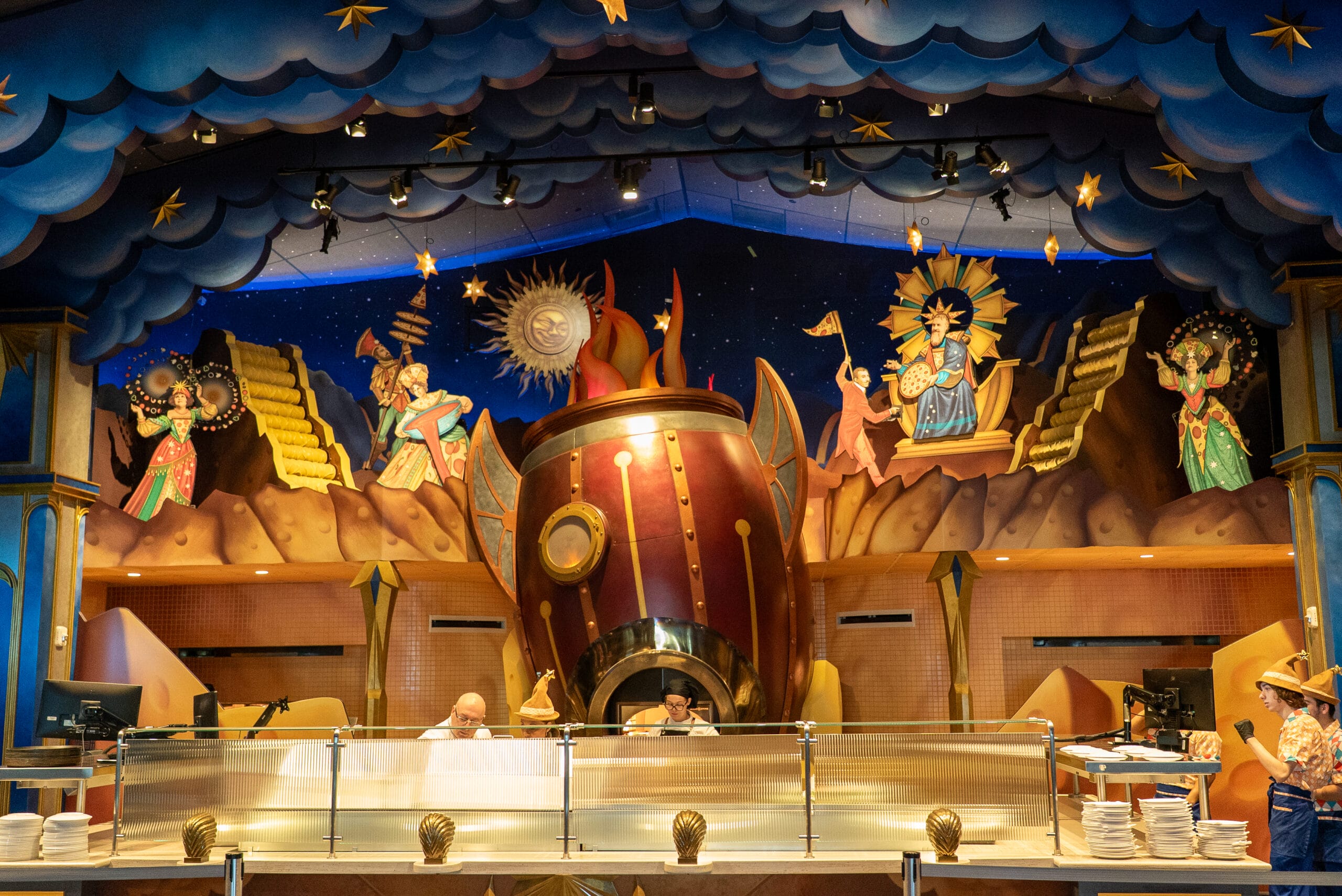 Colorful Pizza Moon Restaurant interior with a fantasy mural and large oven, inspired by Celestial Park’s Epic Universe.
