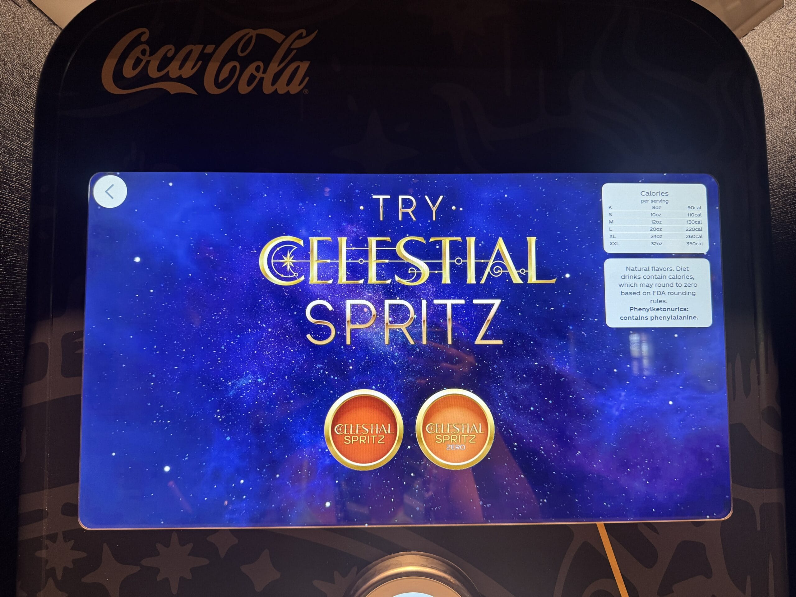 A Coca-Cola Freestyle screen at Pizza Moon Restaurant in Epic Universe displays “Try Celestial Spritz” with two drink options.
