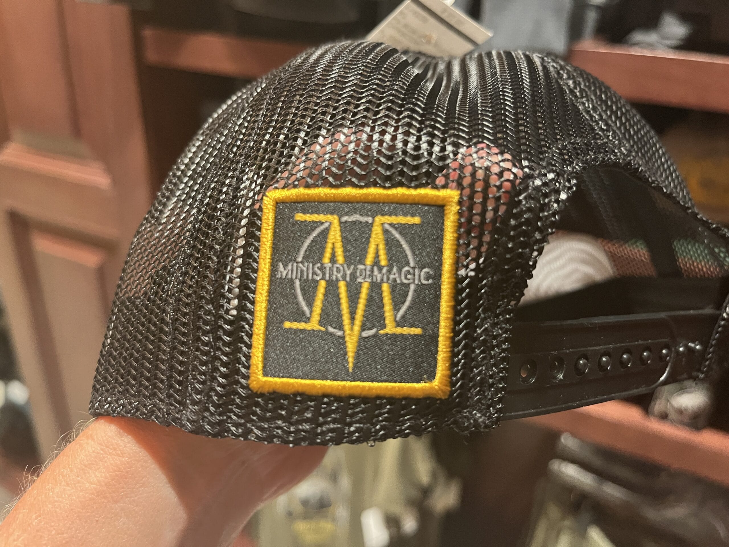 A black mesh cap with a yellow "Ministry of Magic" patch—perfect Wizarding World merchandise for any Harry Potter tour.