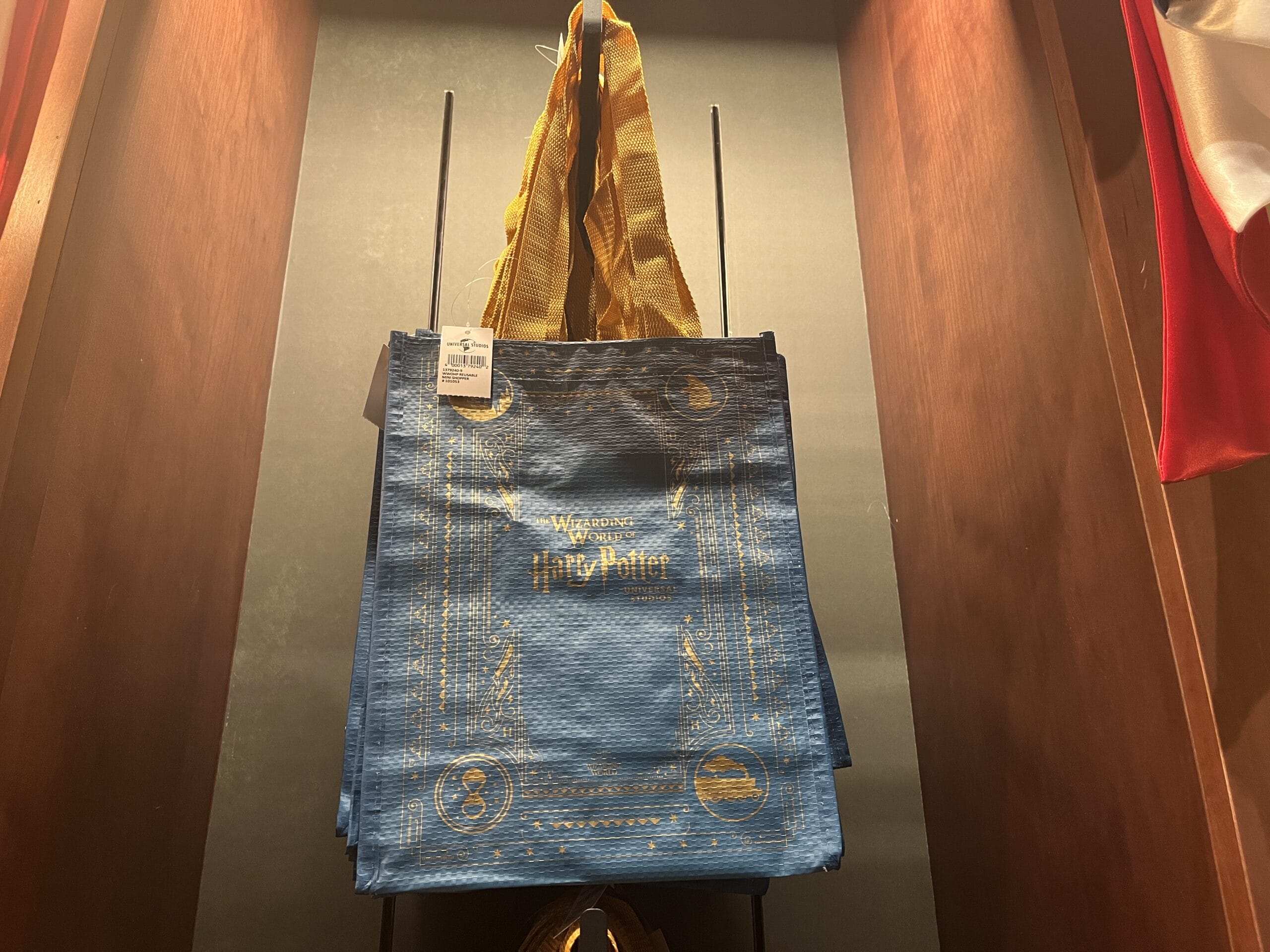 Blue Harry Potter-themed reusable tote bags with gold designs, perfect for Wizarding World merchandise collectors.