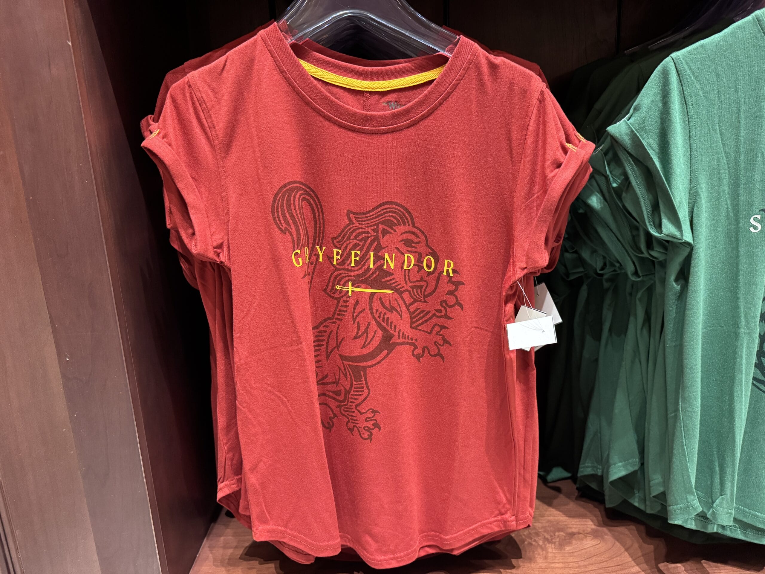 Red t-shirt with a gold lion and "GRYFFINDOR" in yellow—perfect Wizarding World of Harry Potter merchandise.