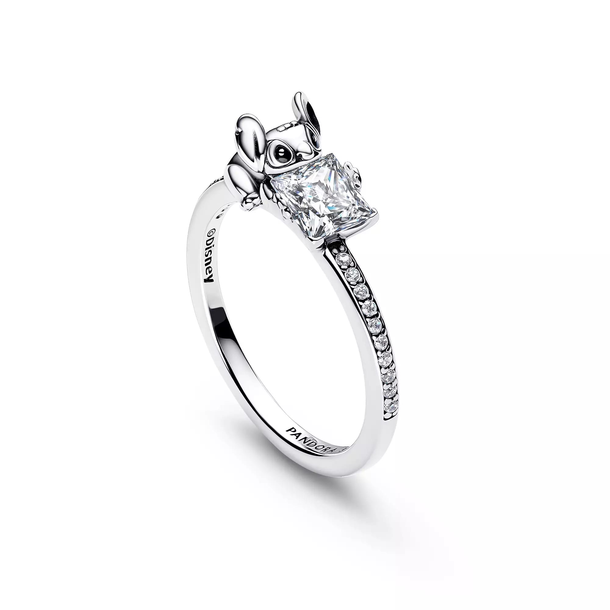 Silver ring with a diamond-studded band and a stylized mouse-shaped setting, inspired by Disney Store elegance.