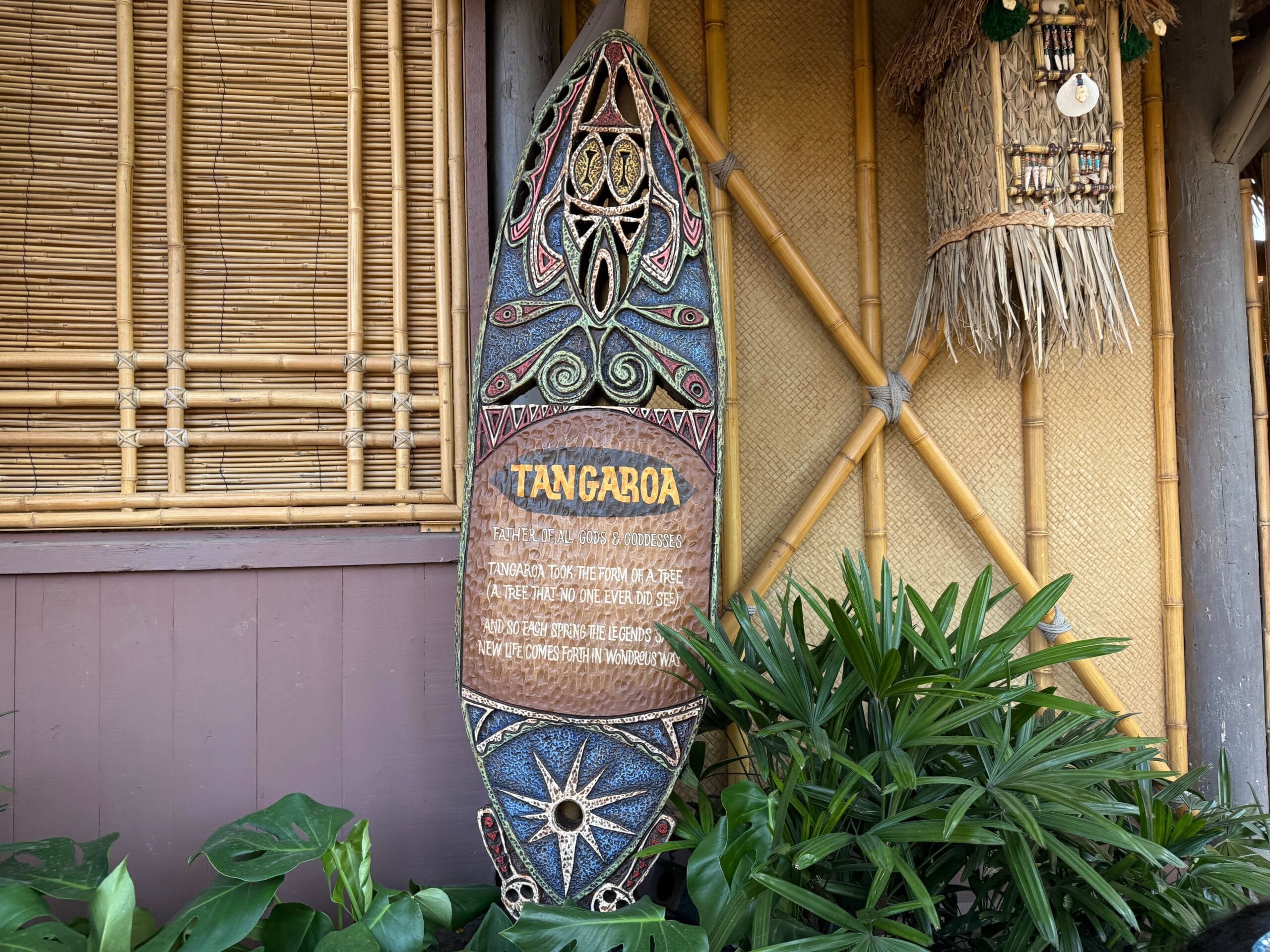 A decorative surfboard with colorful tribal patterns brightens the Enchanted Tiki Garden near Walt Disney’s Enchanted Tiki Room.
