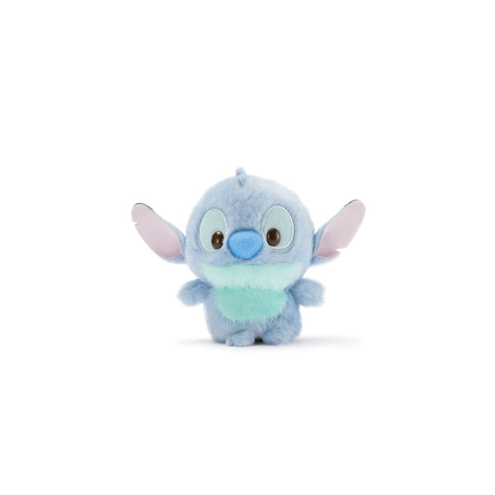 A small Stitch plush from Disney Store Japan, with blue fur, big eyes, and large ears, sitting upright.