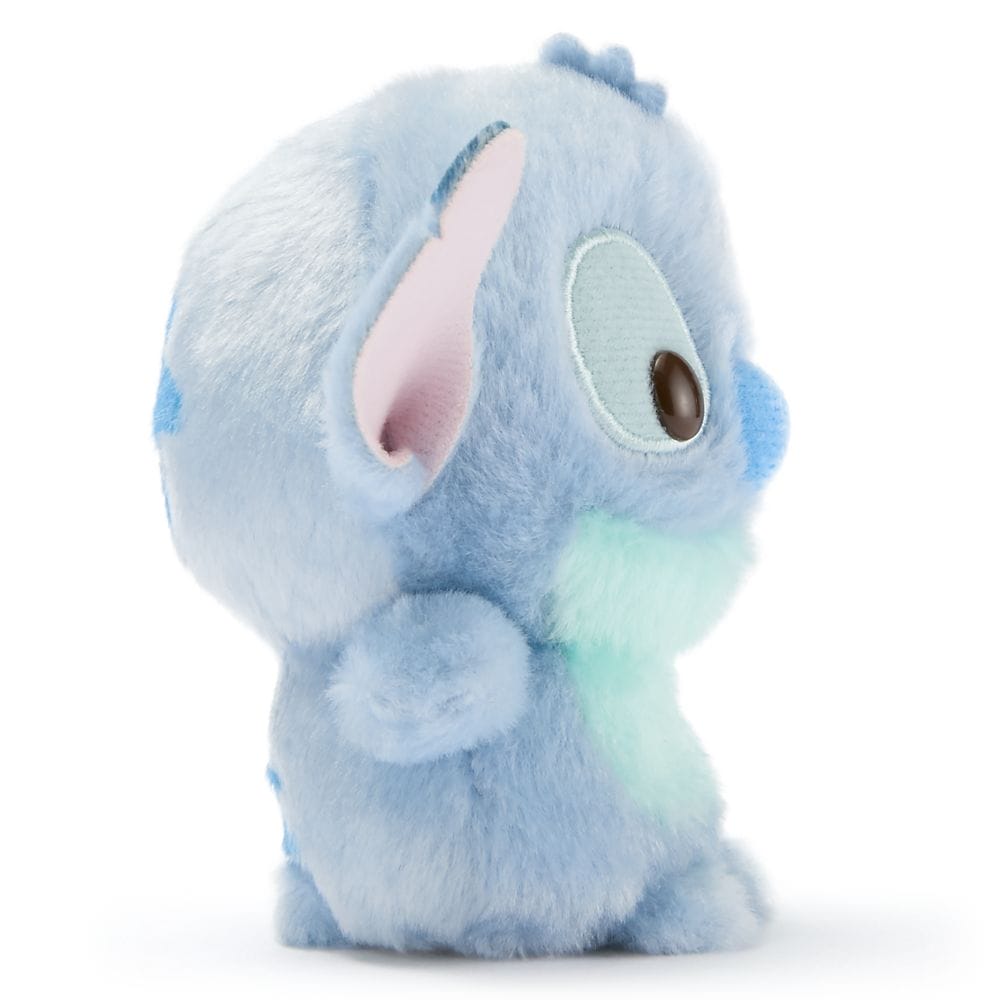 A plush toy of Stitch, the blue alien, shown in side profile, from Disney Store Japan on a white background.