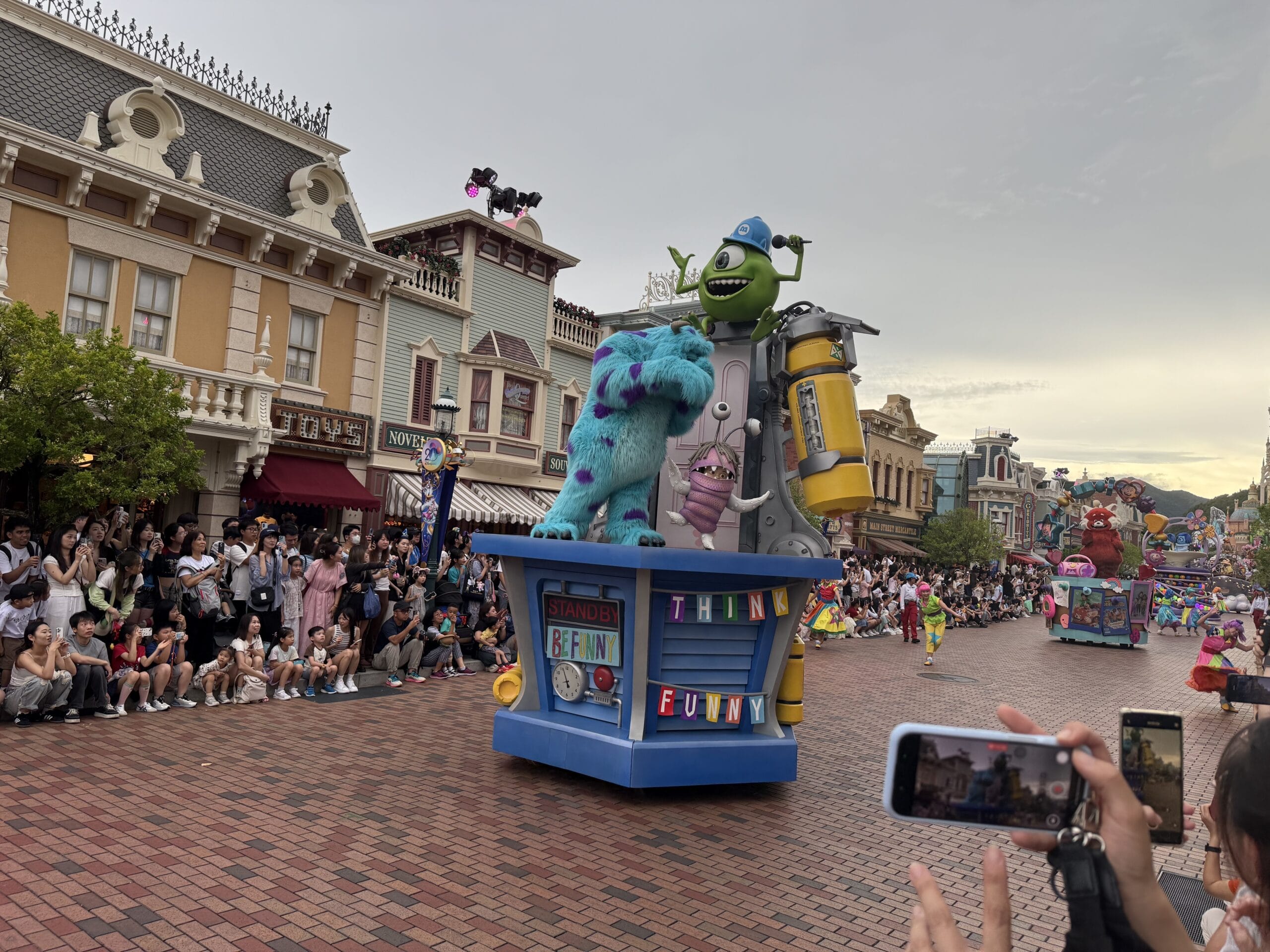 A colorful friendtastic parade float with Monsters, Inc. characters delights crowds at Hong Kong Disneyland.