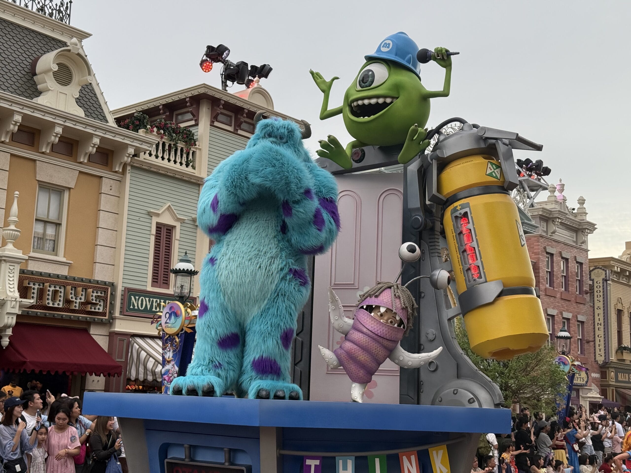 Sulley and Mike Wazowski star on a float in the Hong Kong Disneyland Friendtastic Parade, cheered by excited crowds.
