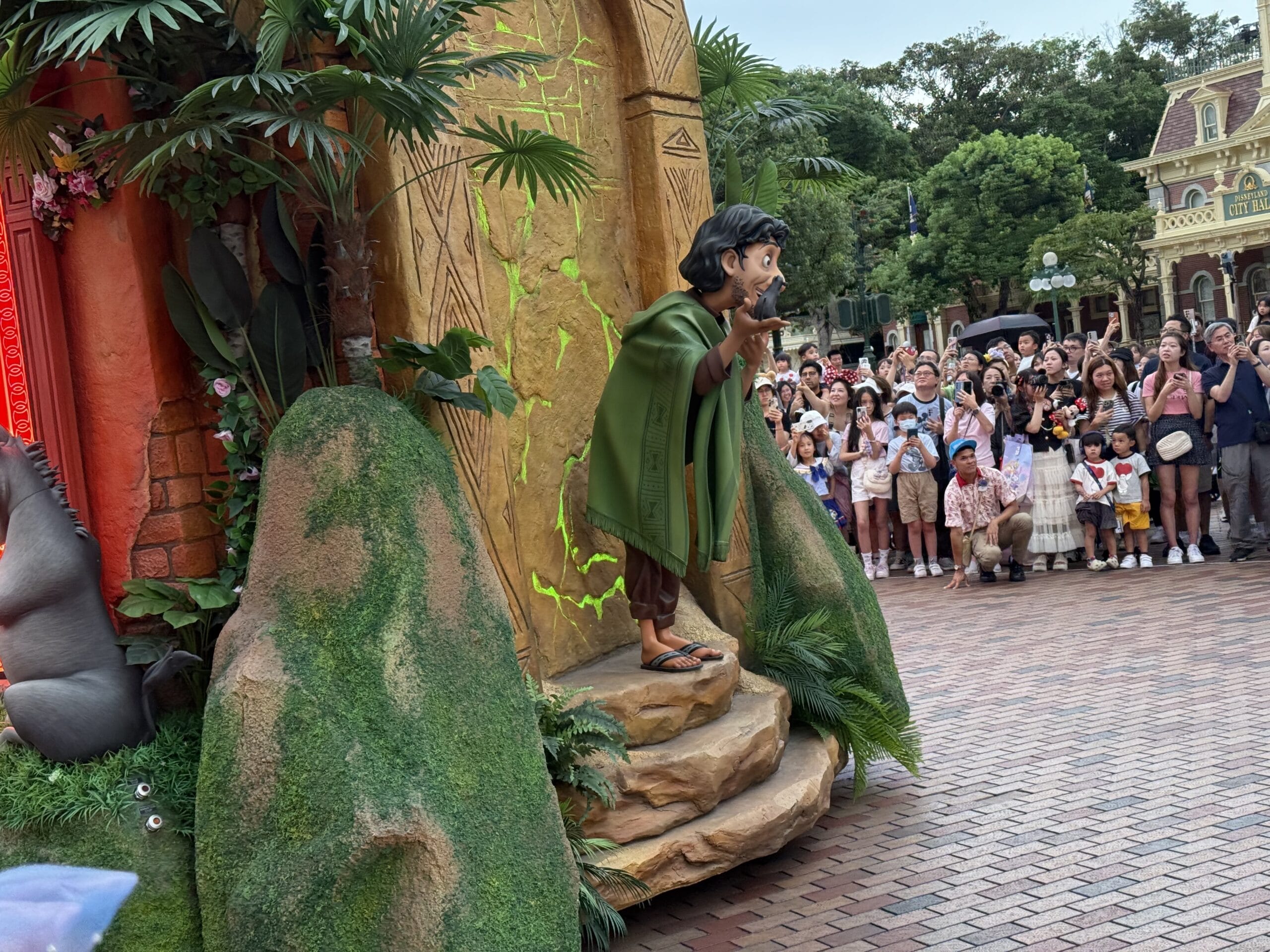 A performer dressed as Bruno from Encanto entertains a crowd at the Hong Kong Disneyland Friendtastic Parade.