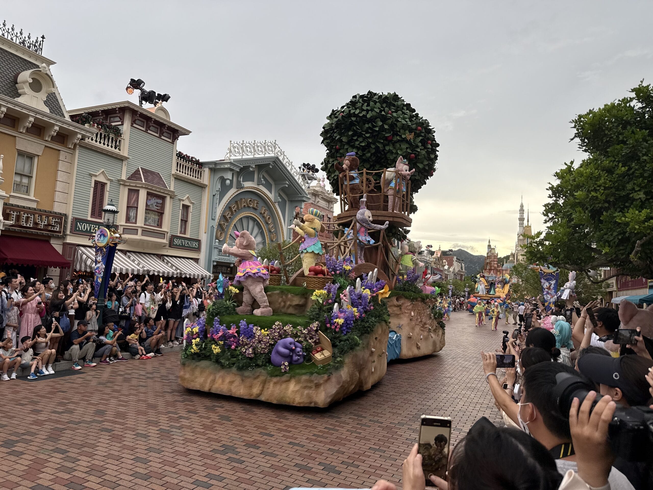 The Friendtastic Parade float with Disney characters delights crowds on Main Street at Hong Kong Disneyland.