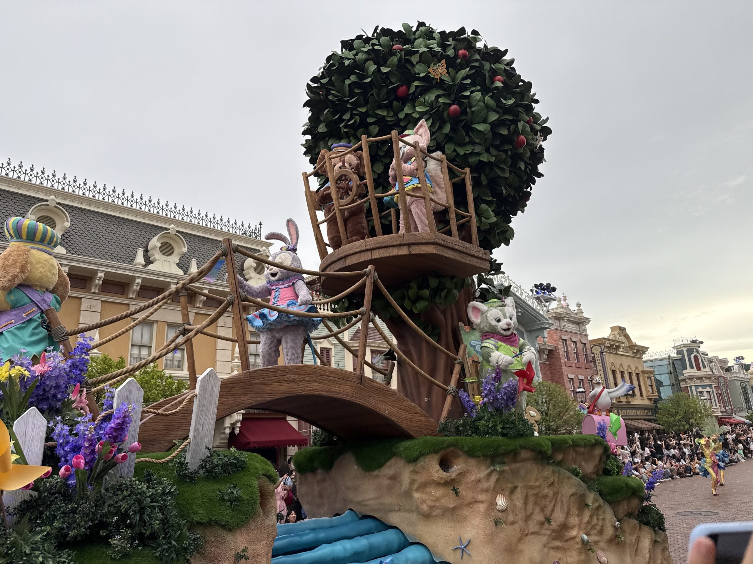 Parade float with costumed rabbits on a treehouse and bridge at the friendtastic parade in Hong Kong Disneyland.