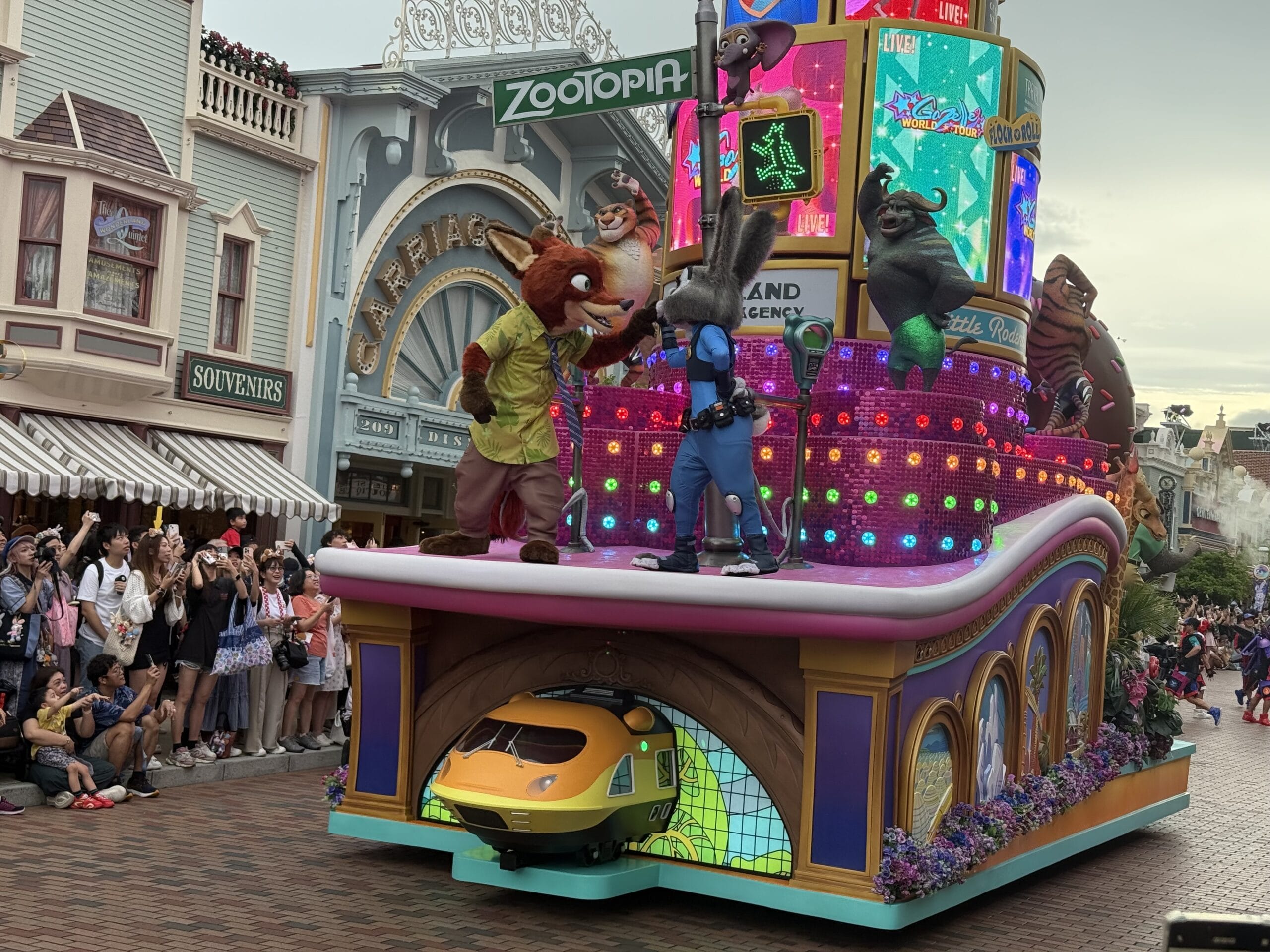 Colorful friendtastic parade float with Zootopia characters and bright lights delights crowds at Hong Kong Disneyland.