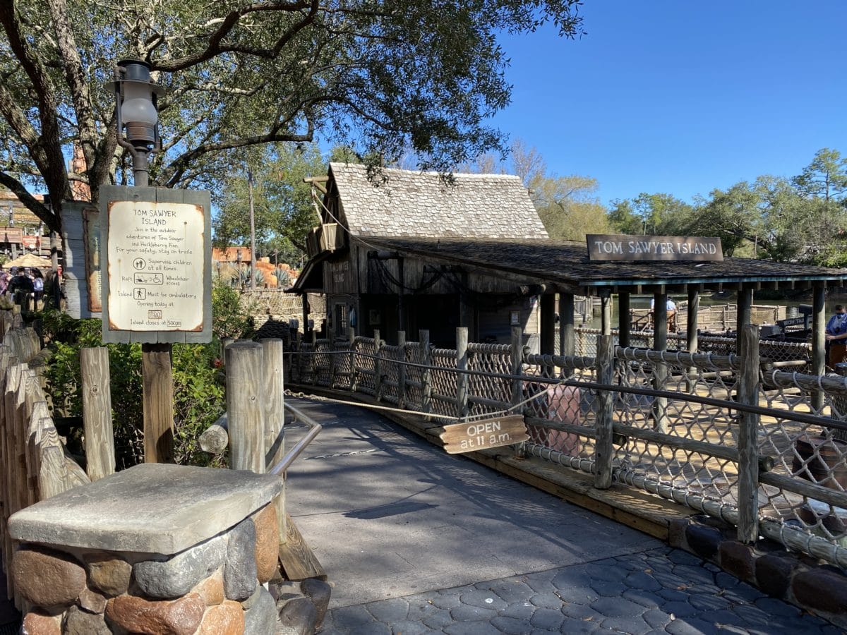 Wooden walkway and rustic building at Tom Sawyer Island entrance. Tom Sawyer island closing date announced