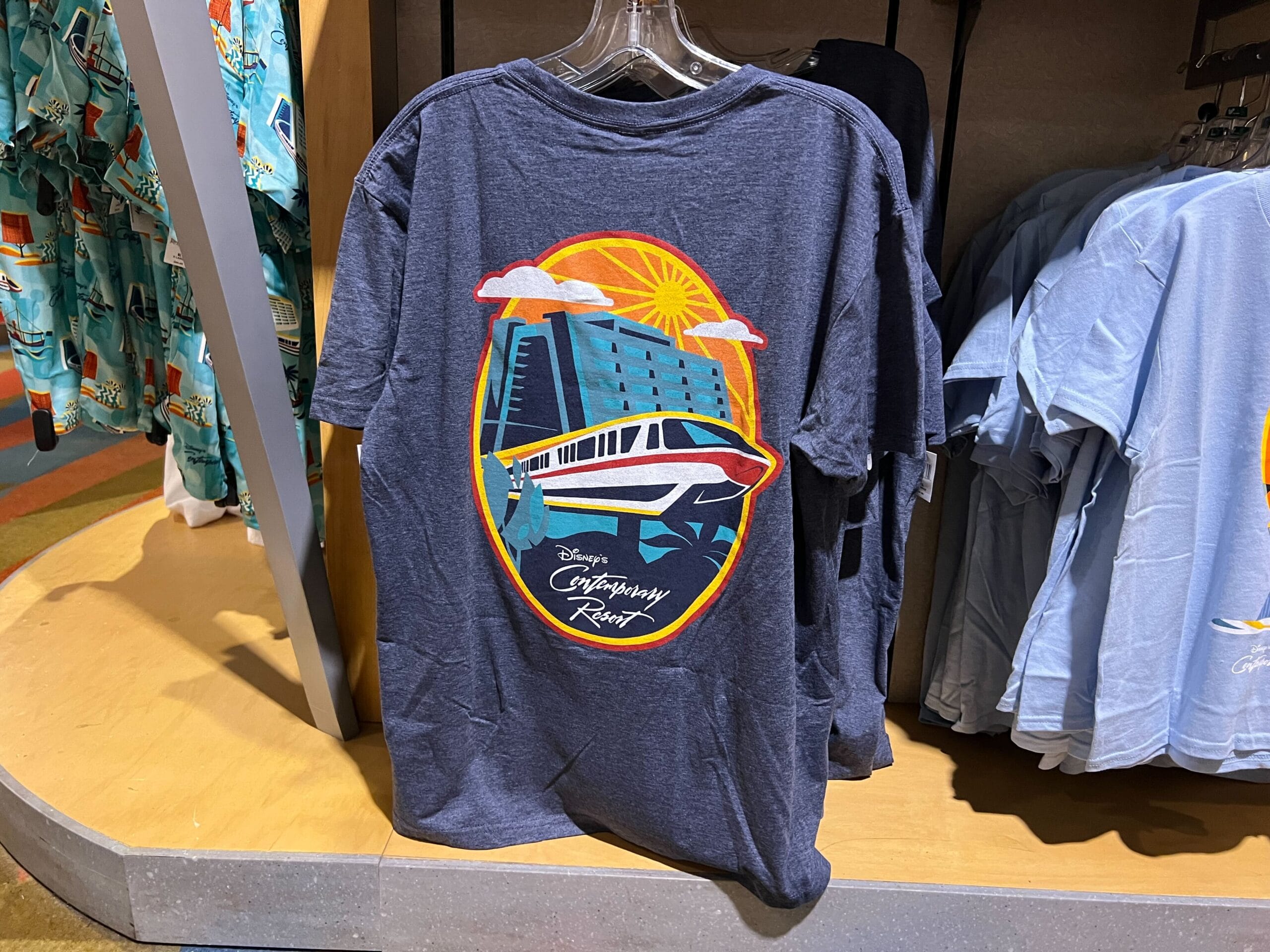 Dark gray t-shirt featuring a monorail, sun, and Contemporary Resort with stylized Disney text on the back.