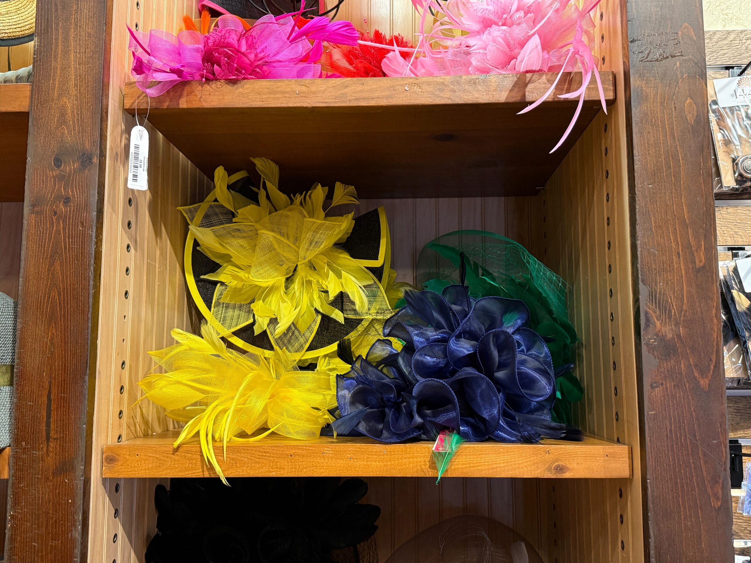 Colorful decorative hats made of mesh and feathers are displayed in the Hat Shop at Magic Kingdom.