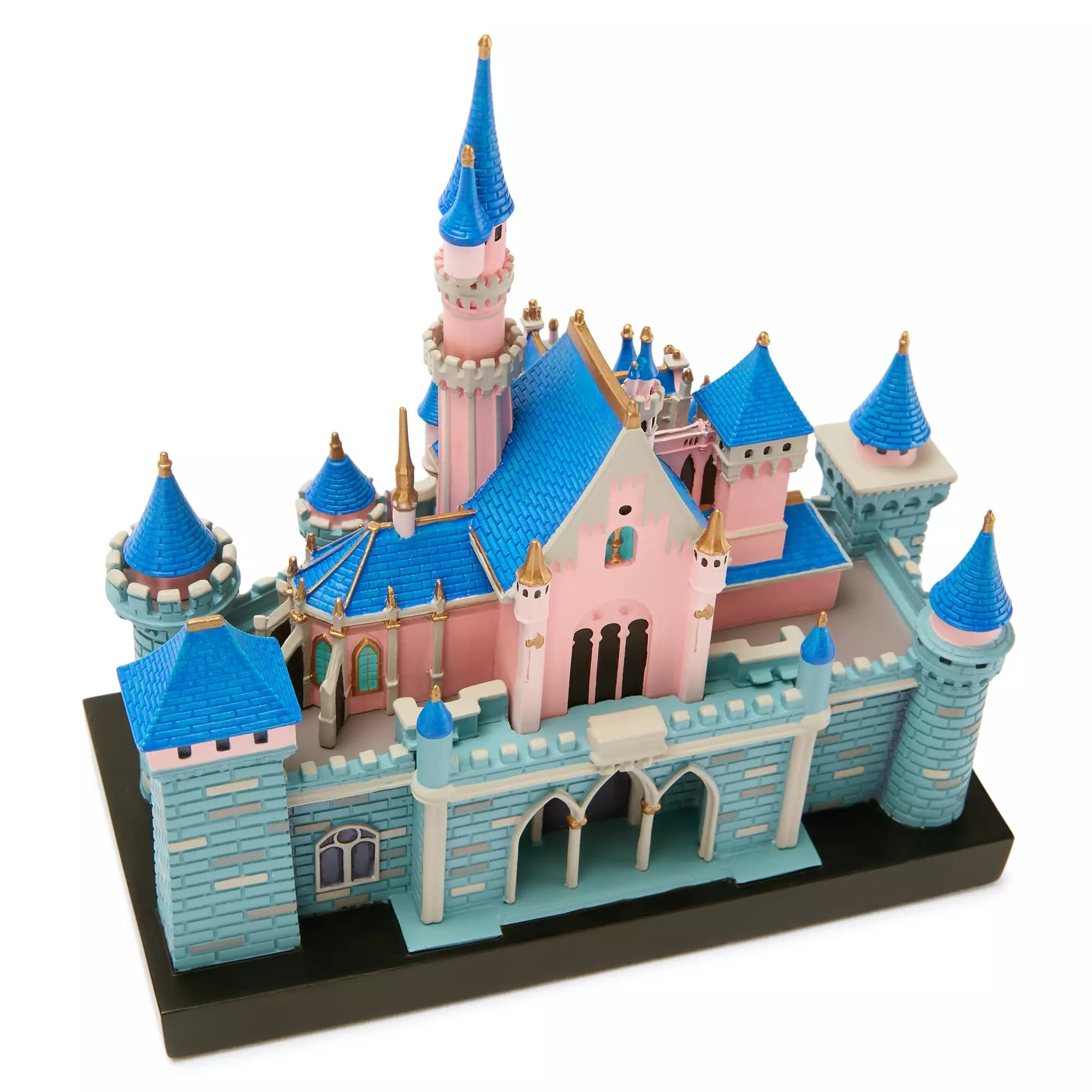 A miniature model of a castle with blue roofs, pink walls, and detailed towers on a black base.
