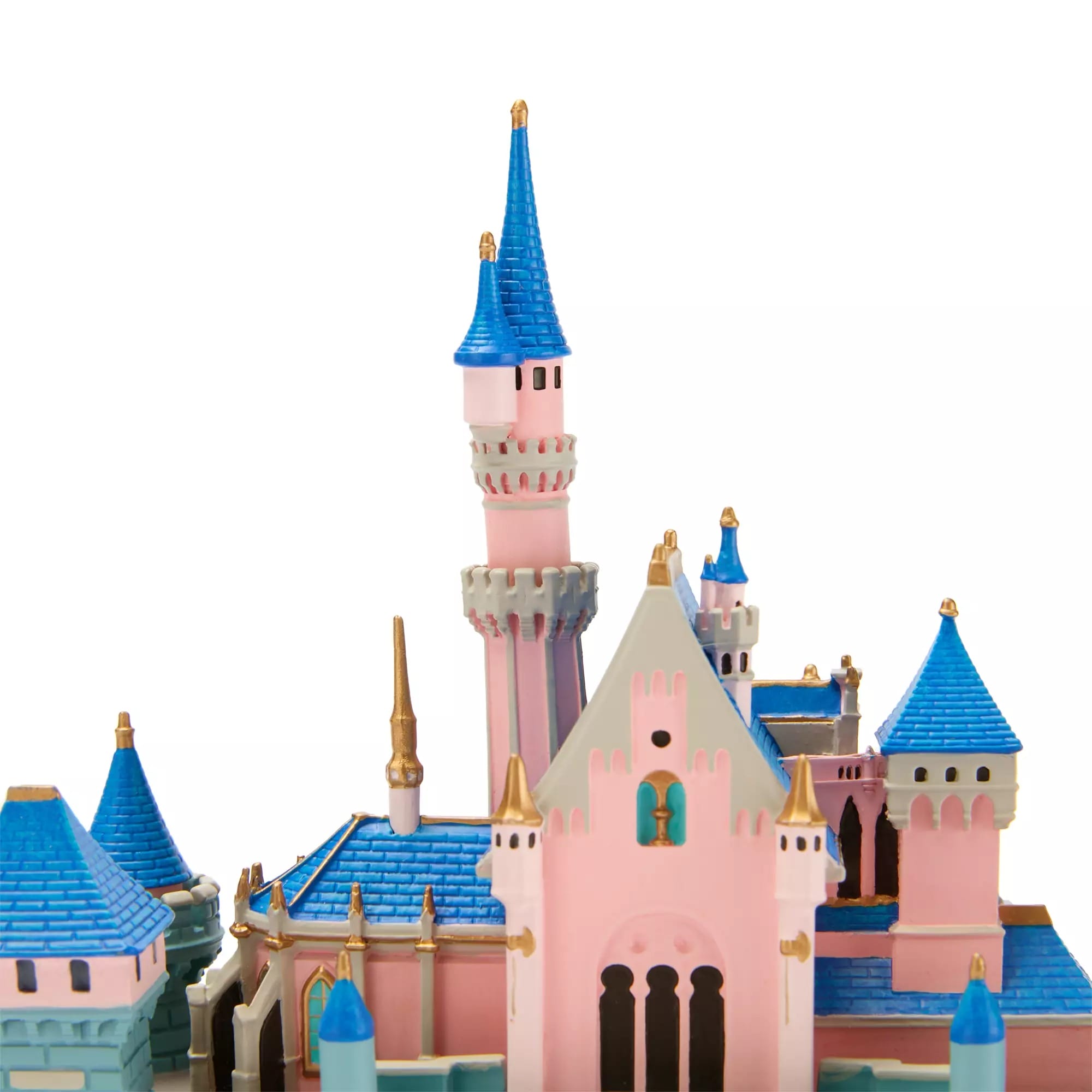 A pink and blue toy castle with tall spires, towers, and gold accents against a white background.