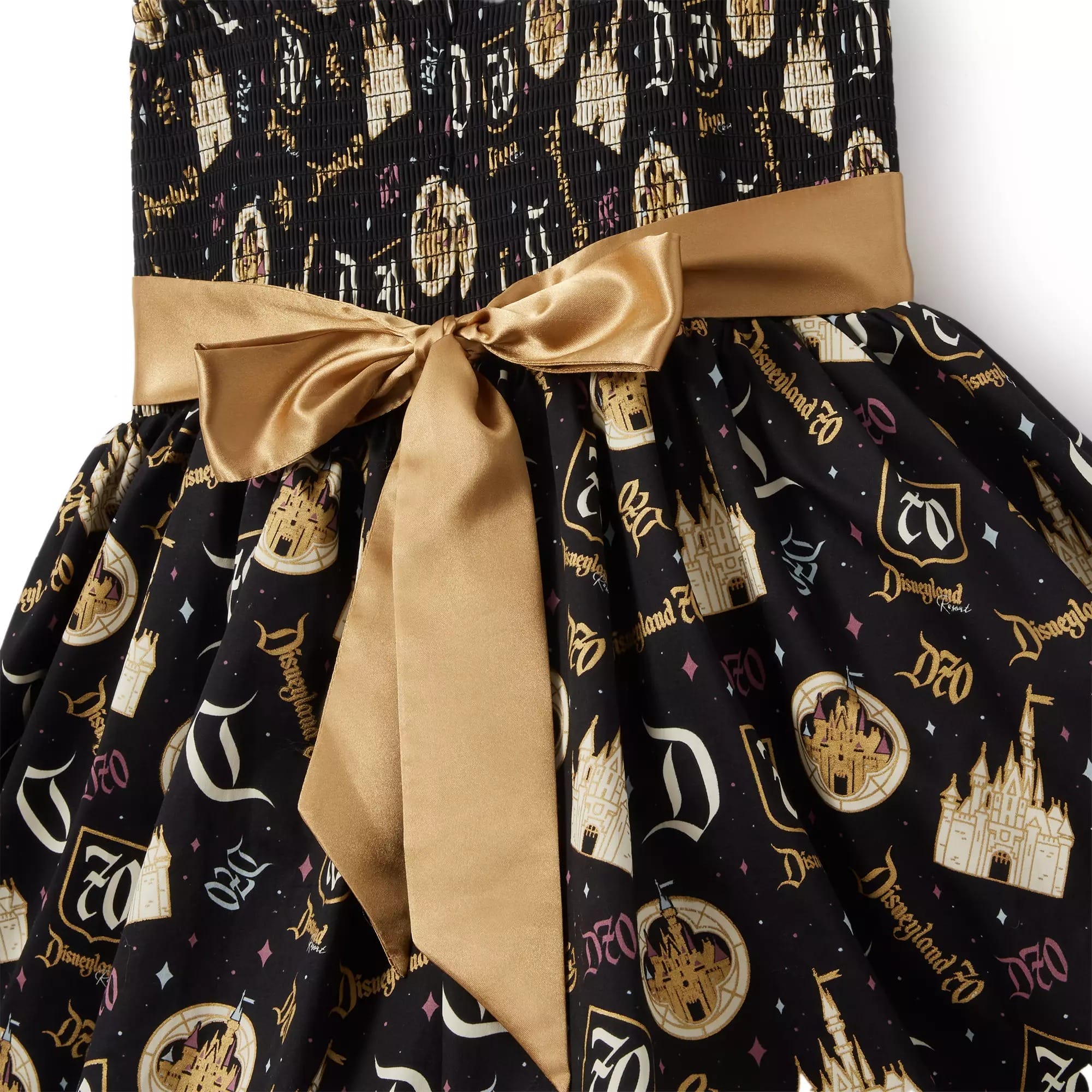 Black and gold Disneyland-themed dress with a shiny gold bow and castle, Disneyland, and “D” logo patterns.