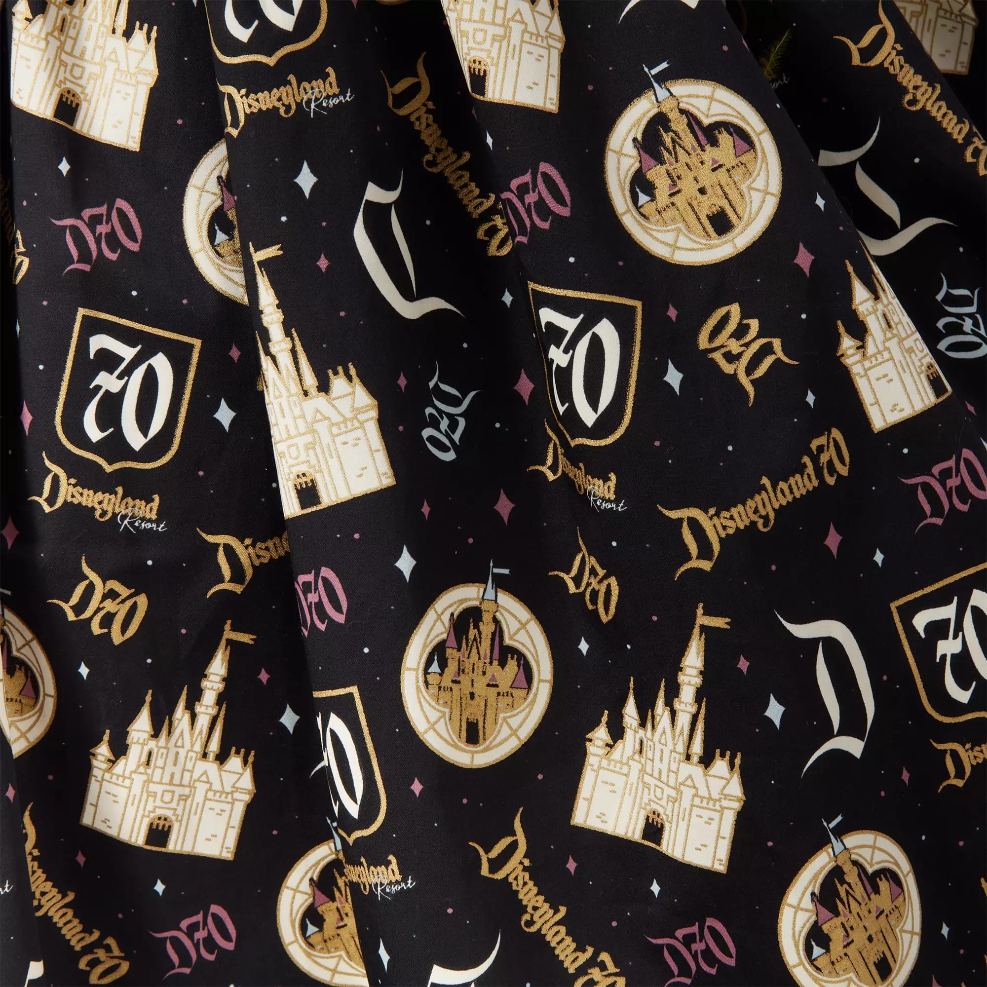 Black fabric with gold Disneyland castle, "70," and "Disneyland Resort" anniversary logos and decorative icons.