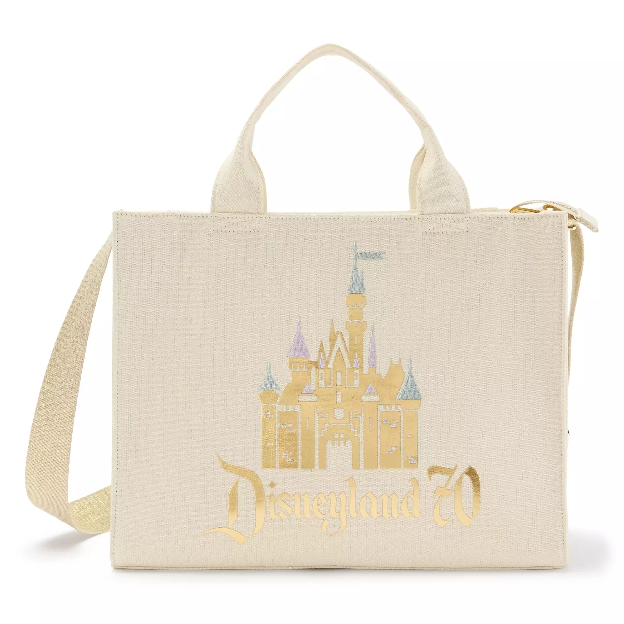 Cream-colored tote bag with a gold Sleeping Beauty Castle and "Disneyland 70" text printed on the front.