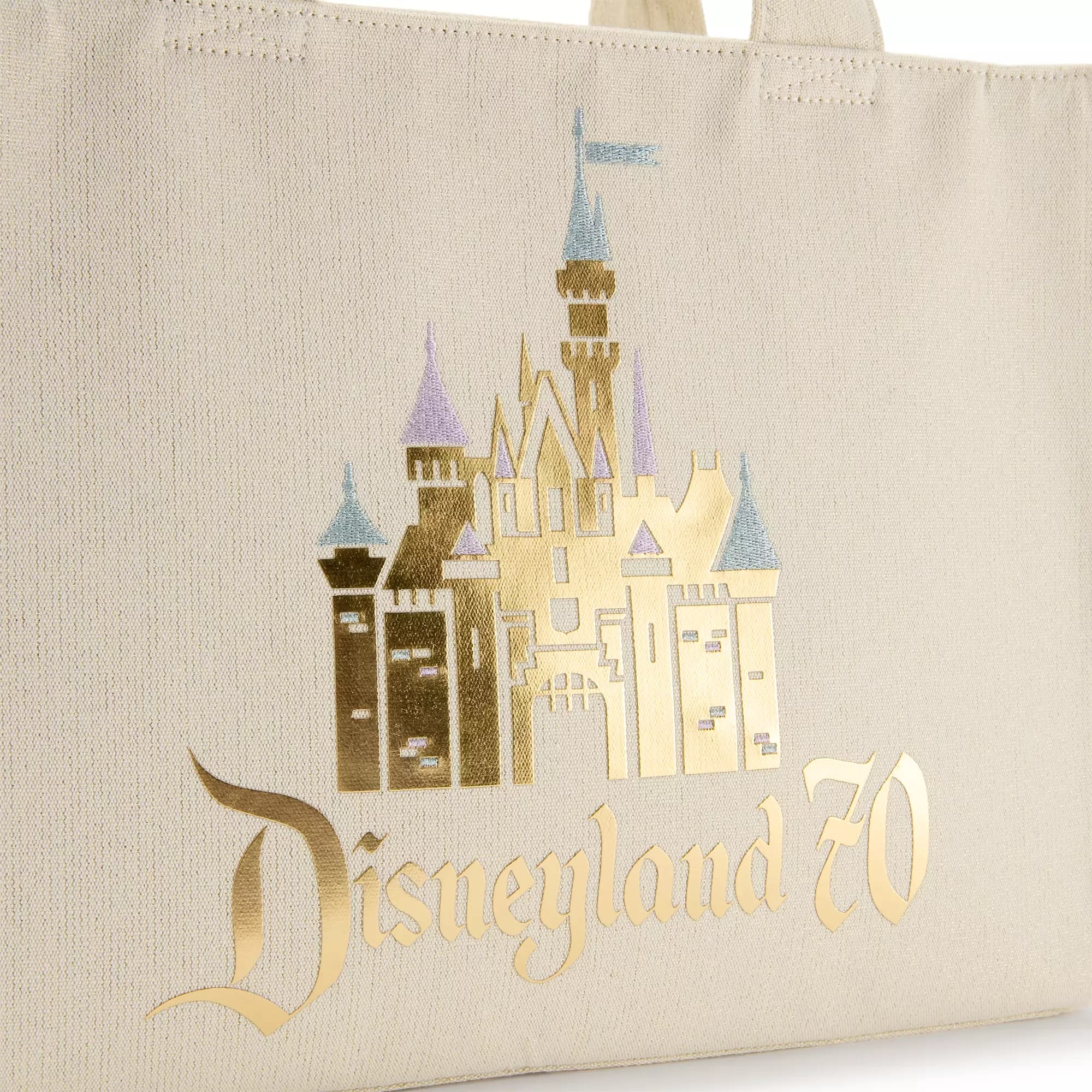 Beige tote bag with a gold Sleeping Beauty Castle and "Disneyland 70" written in gold lettering.