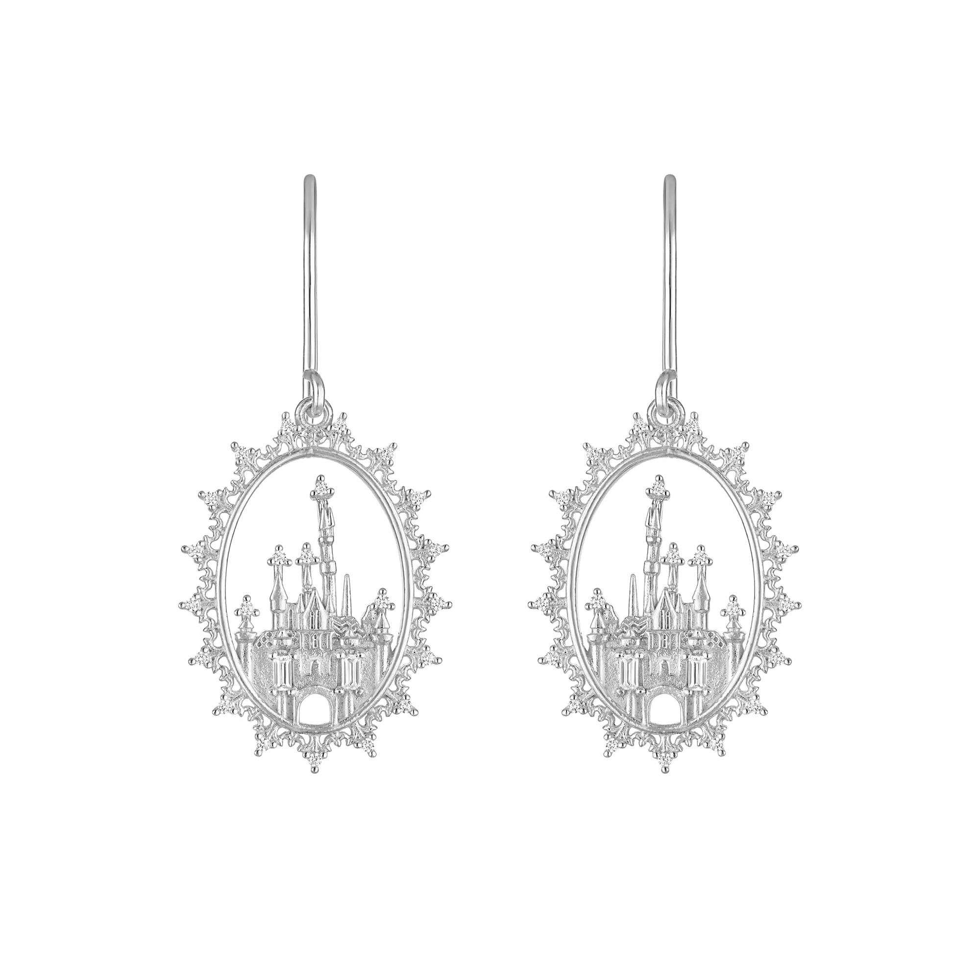 Silver earrings featuring an ornate oval frame with a detailed castle design inside, shown against a white background.