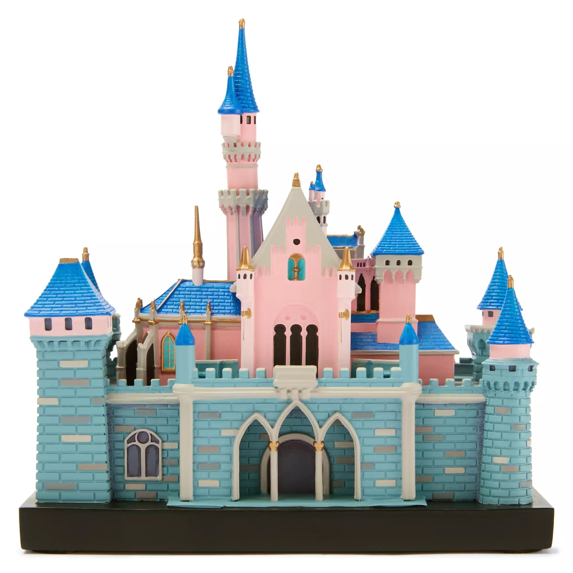 A detailed model of a pink and blue fairytale castle with towers, arches, and gold accents on a black base.
