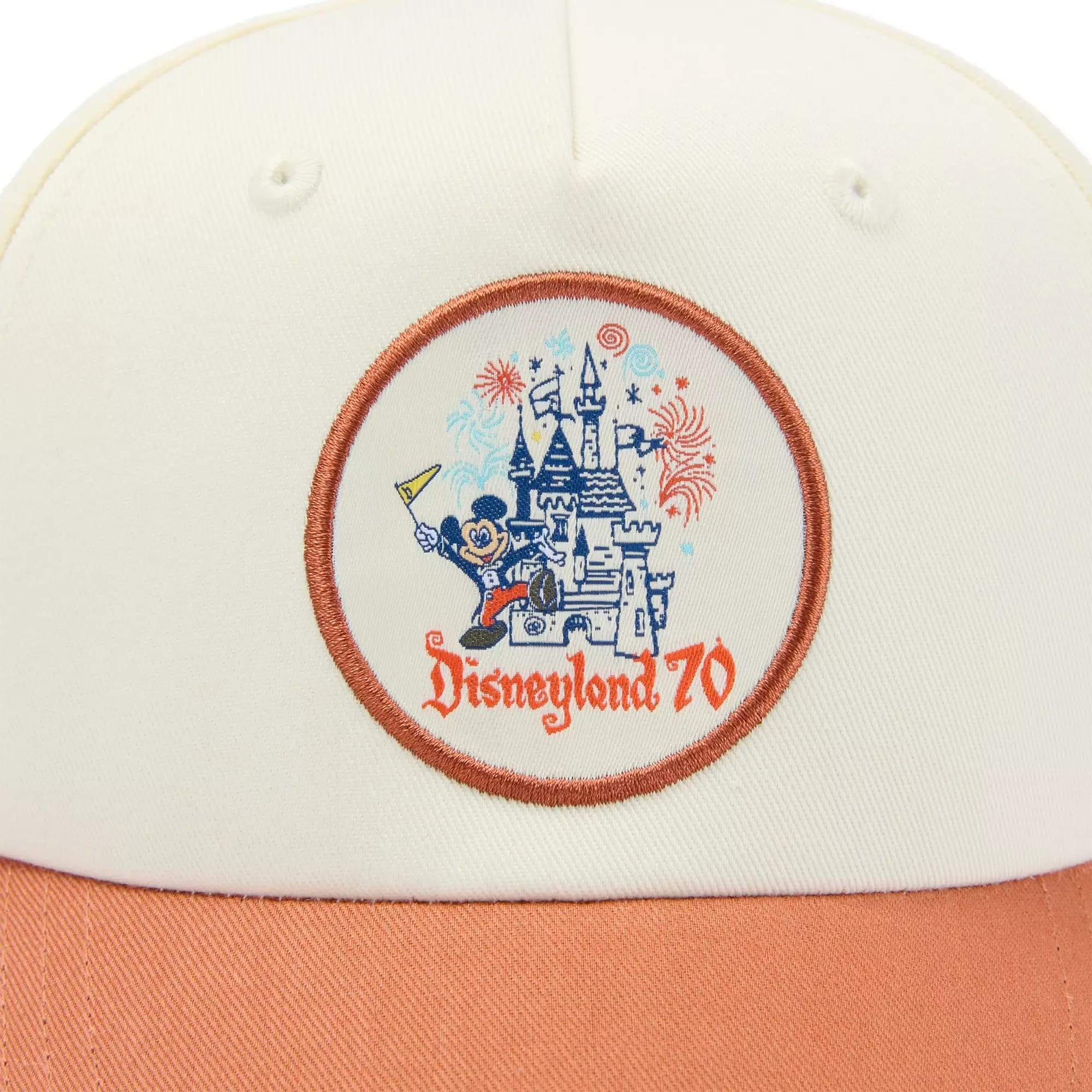 Close-up of a cap with a "Disneyland 70" patch featuring a castle, Mickey Mouse, and fireworks.