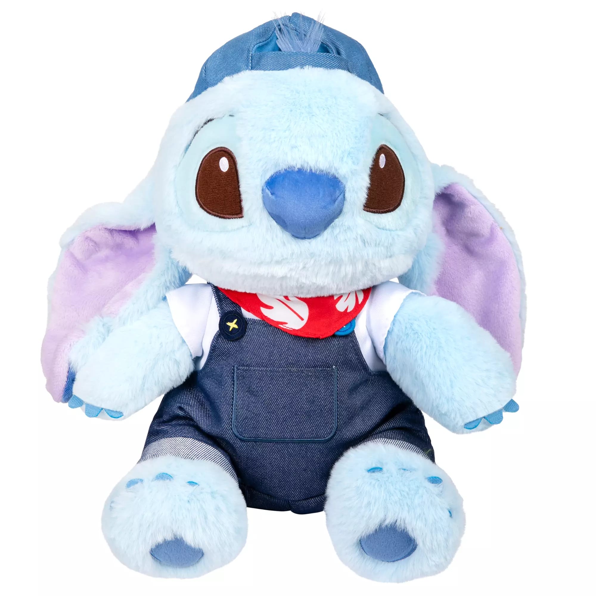 A blue Stitch plush toy with large ears, wearing a blue cap, denim overalls, and a red bandana from Disney Store.