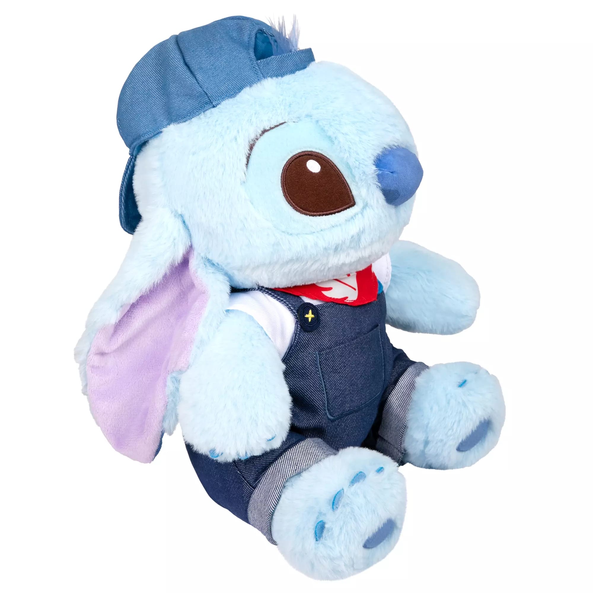 A Stitch plush from Disney Store China in denim overalls, a red bandana, and cap sits upright looking adorable.