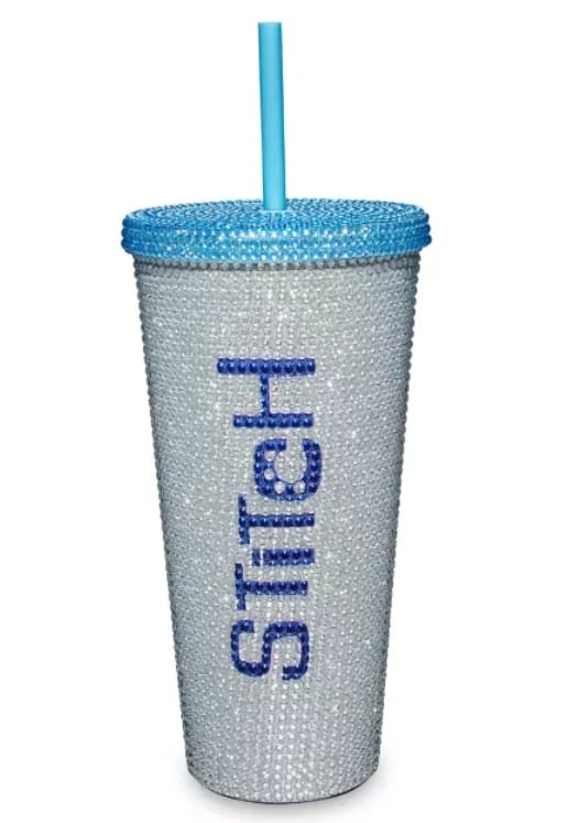 A glittery Lilo & Stitch tumbler with "Stitch" on it plus a blue lid and straw—perfect for Disney merchandise lovers!