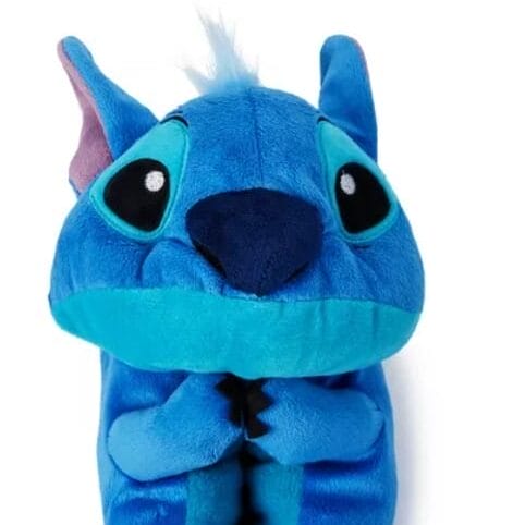 Plush toy of Stitch from "Lilo & Stitch" merchandise, wrapped in blue fur with large black and blue eyes.