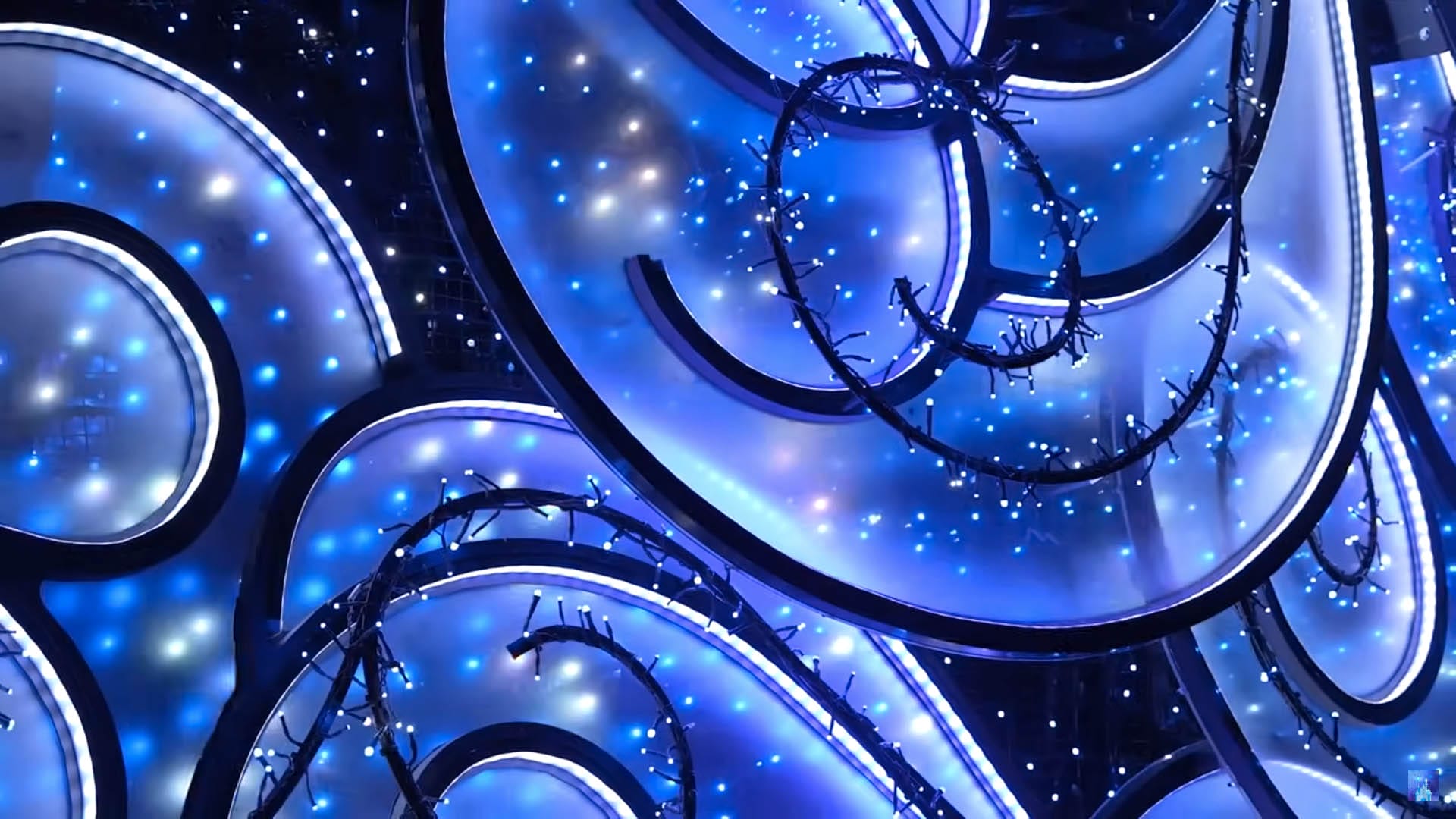 Close up of float details of Swirling blue and white abstract shapes - the magic of Disney Starlight Parade, sparkling against a dark background.