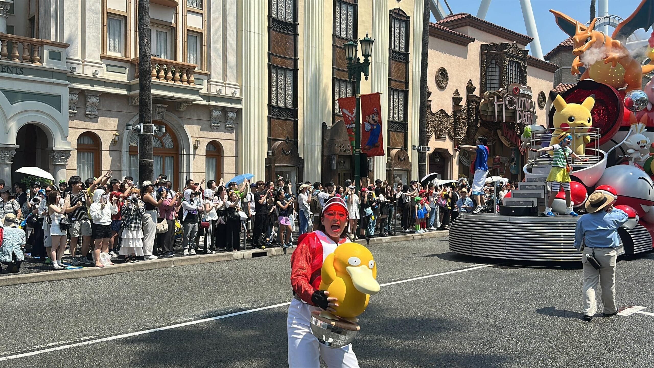A performer with a Psyduck prop delights the crowd during Universal Studios Japan's Summer Splash Parade—perfect for photos.