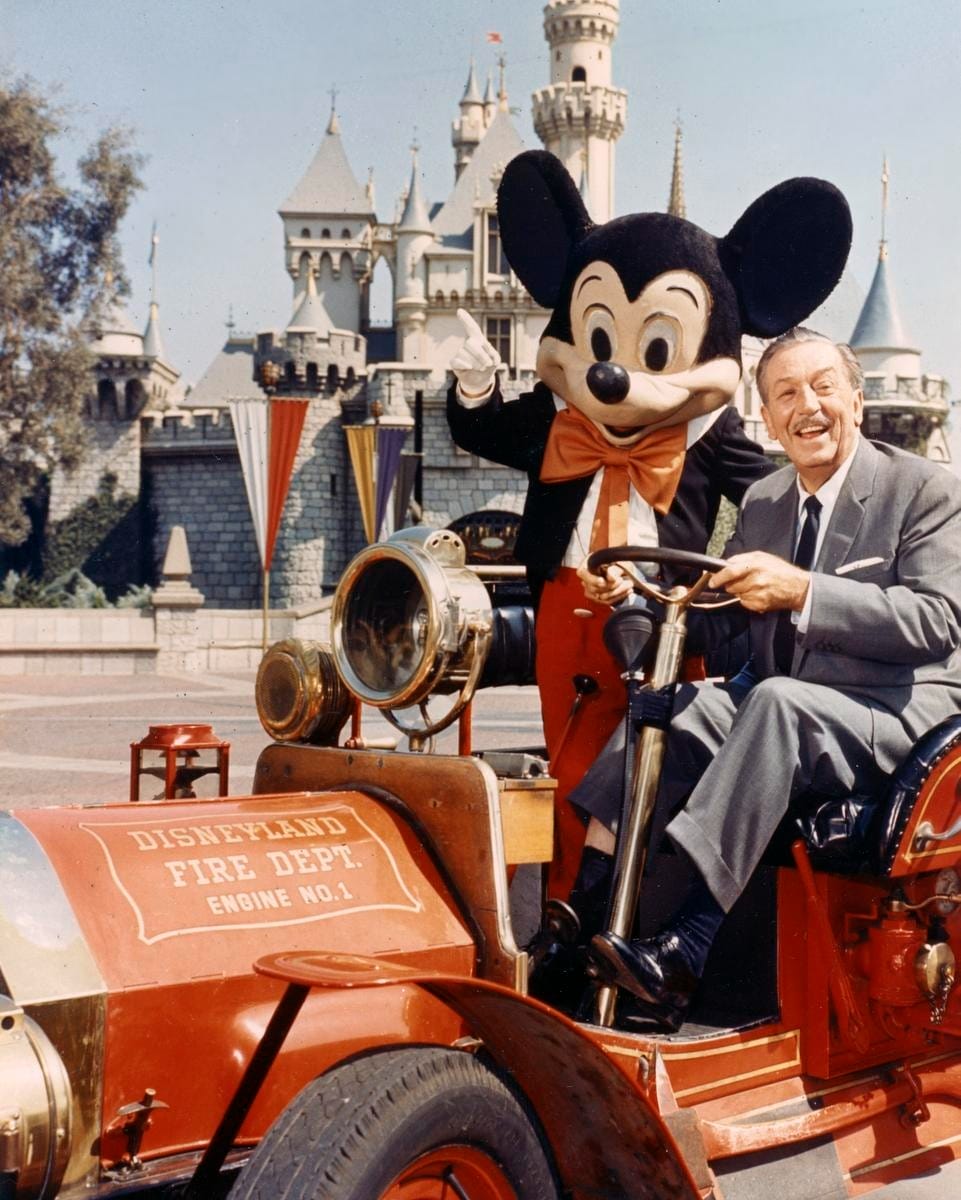 Walt Disney and Mickey Mouse sit on a vintage fire truck at Disneyland for the 70th Anniversary celebration.