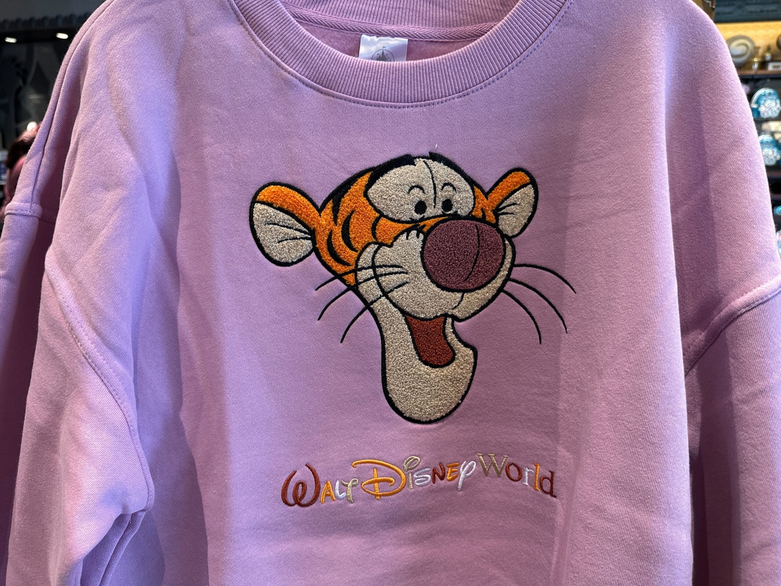 New Arrivals: Lavender Character Sweatshirt featuring Tigger’s face and “Walt Disney World” embroidered below.