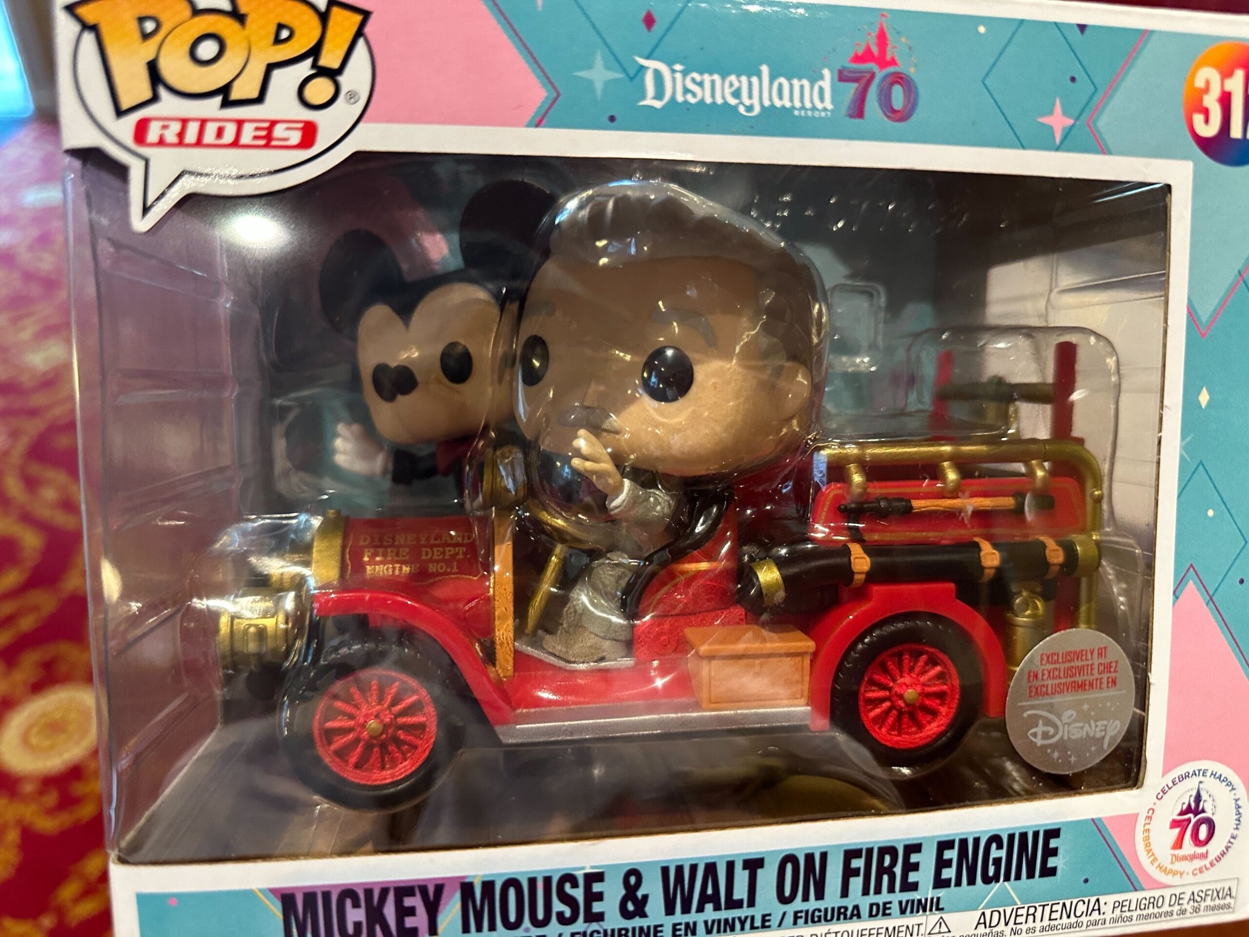 Funko Pop! vinyl figures of Mickey Mouse and Walt Disney riding a red fire engine, in Disneyland 70th anniversary packaging.