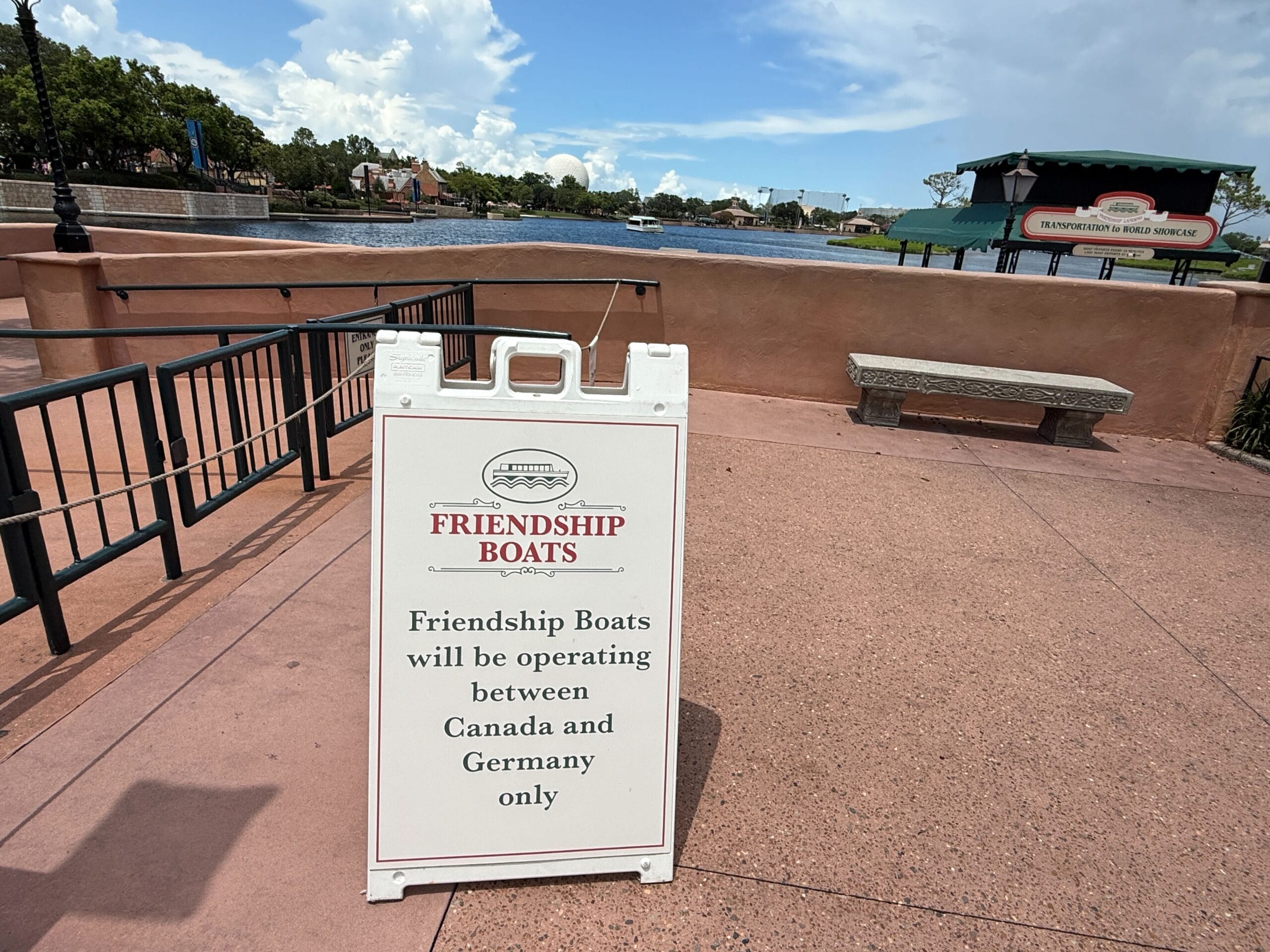 A sign reads: "Friendship Boat Transportation will run between Canada and Germany in EPCOT’s World Showcase.