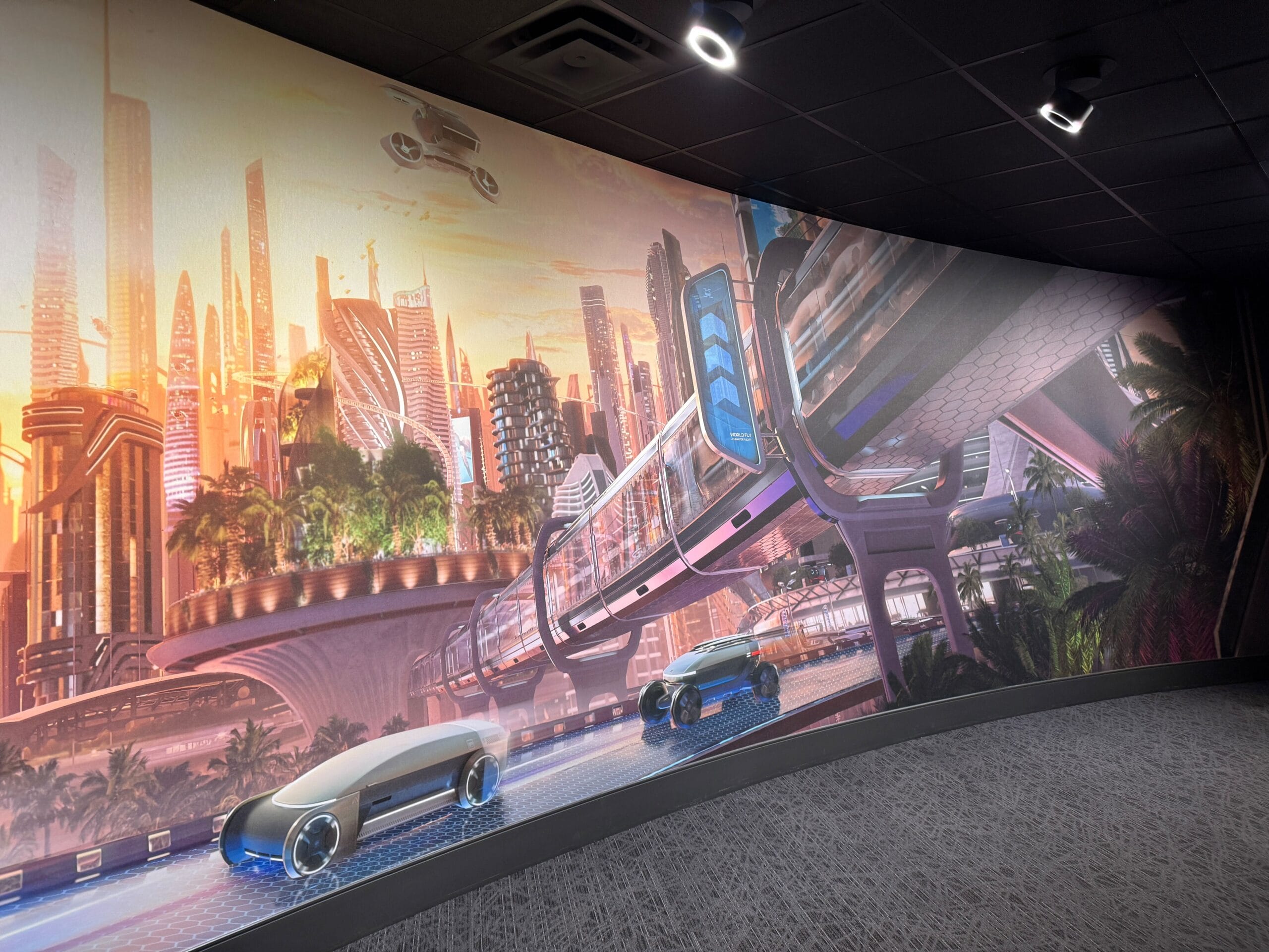 Futuristic city mural with flying cars, monorail, skyscrapers, and two sleek Test Track blue vehicles in the foreground.