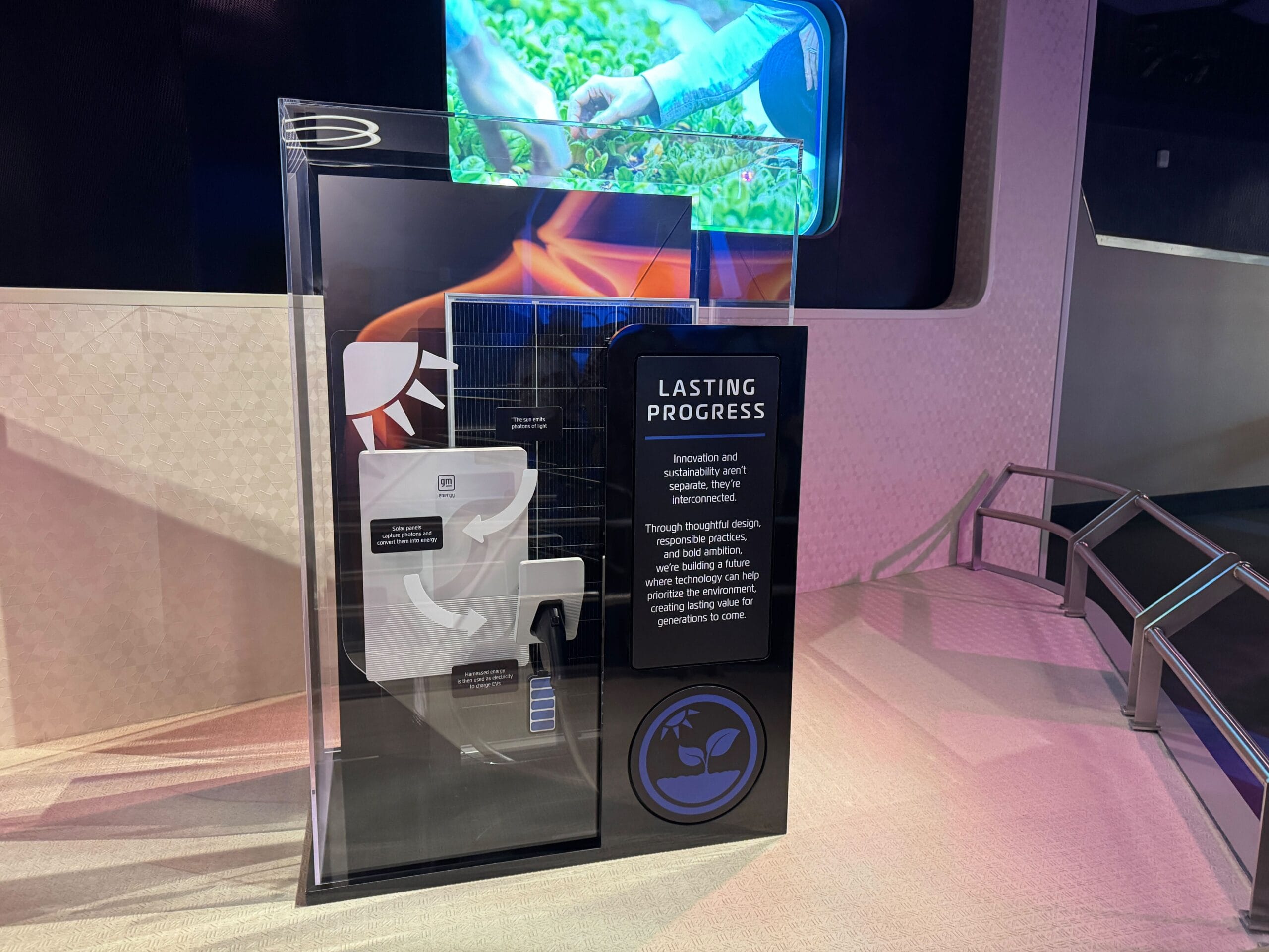 A display case labeled "Lasting Process" with sustainability info and Test Track graphics on a modern exhibit platform.