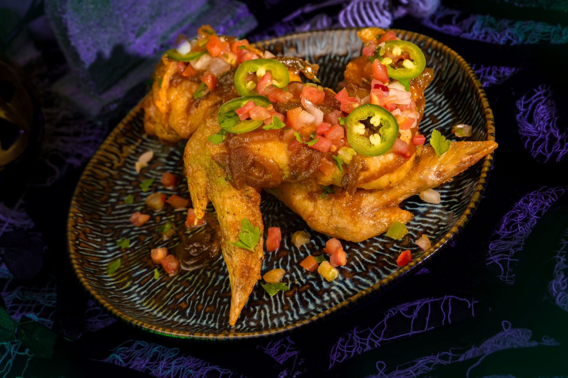 Chicken wings topped with veggies, perfect for 2025 at Mickey's Not So Scary Halloween Party food and beverages lineup.