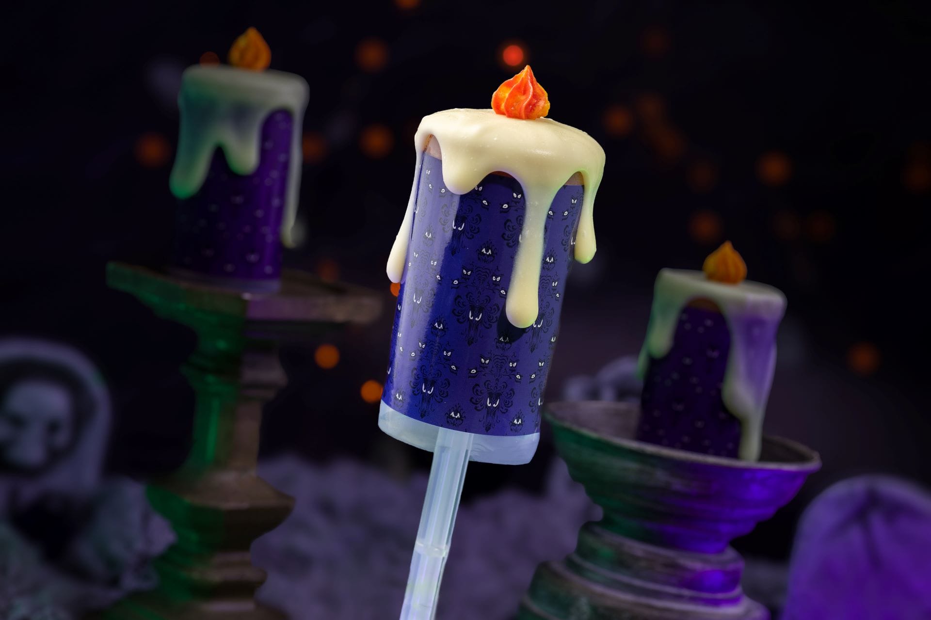 A purple candle-shaped cake pop with white icing, perfect for Mickey's Not So Scary Halloween Party 2025.